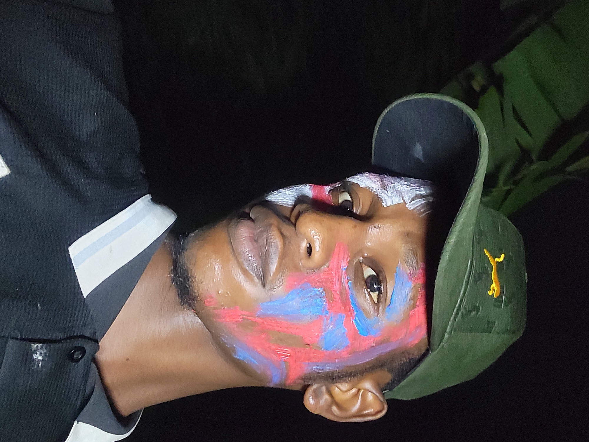Man in patriotic face paint photographed in Nkpor, Nigeria