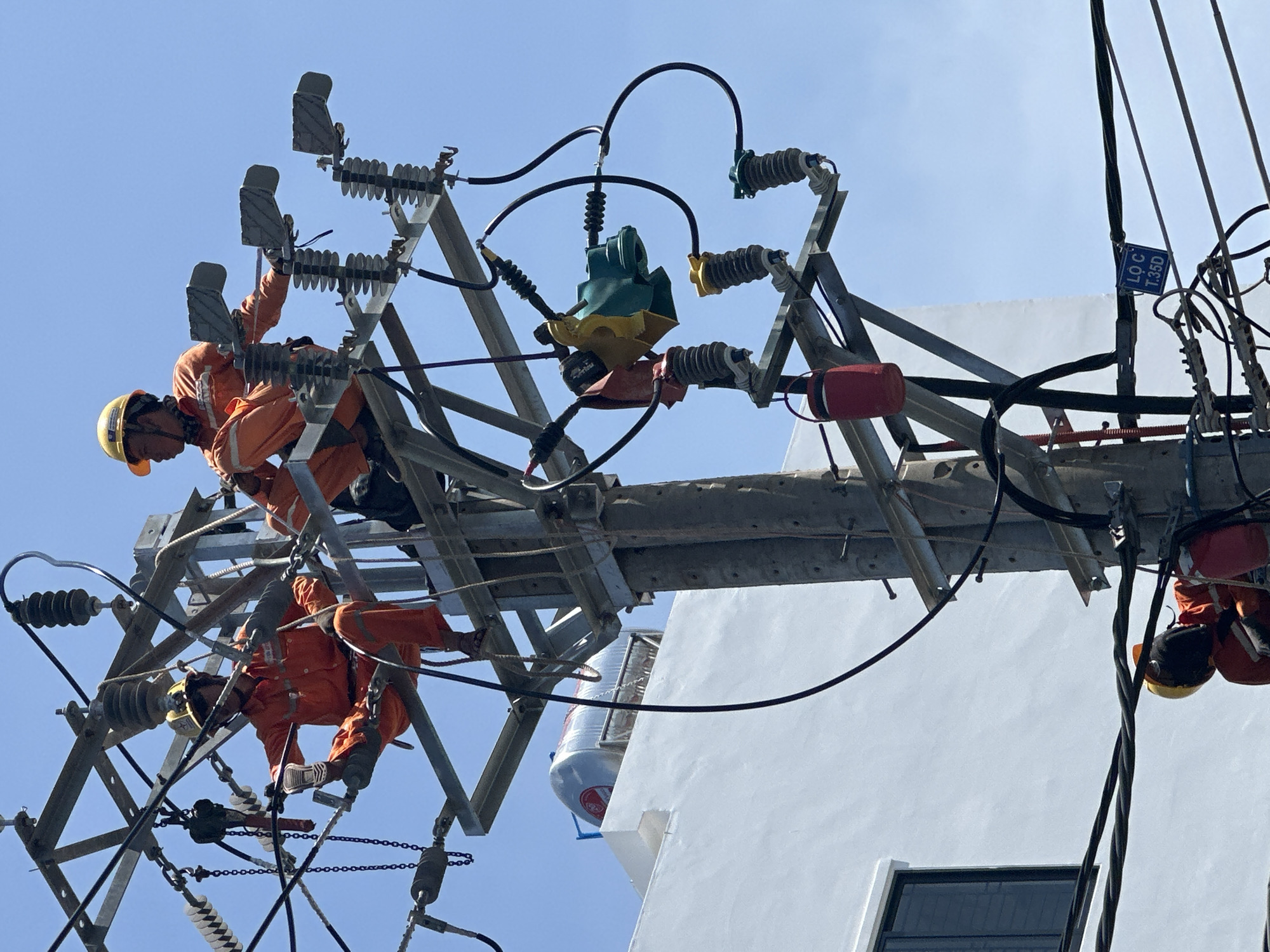 Utility crew does pole work in sunny Nha Trang streets