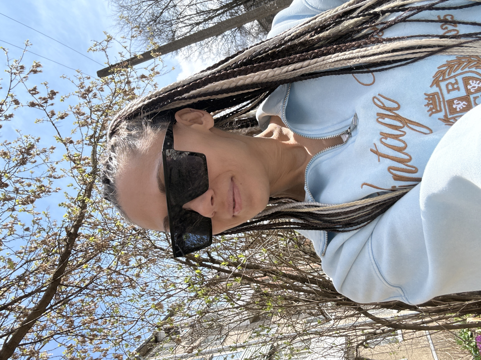 Person captures outdoor selfie with braided hair April 17