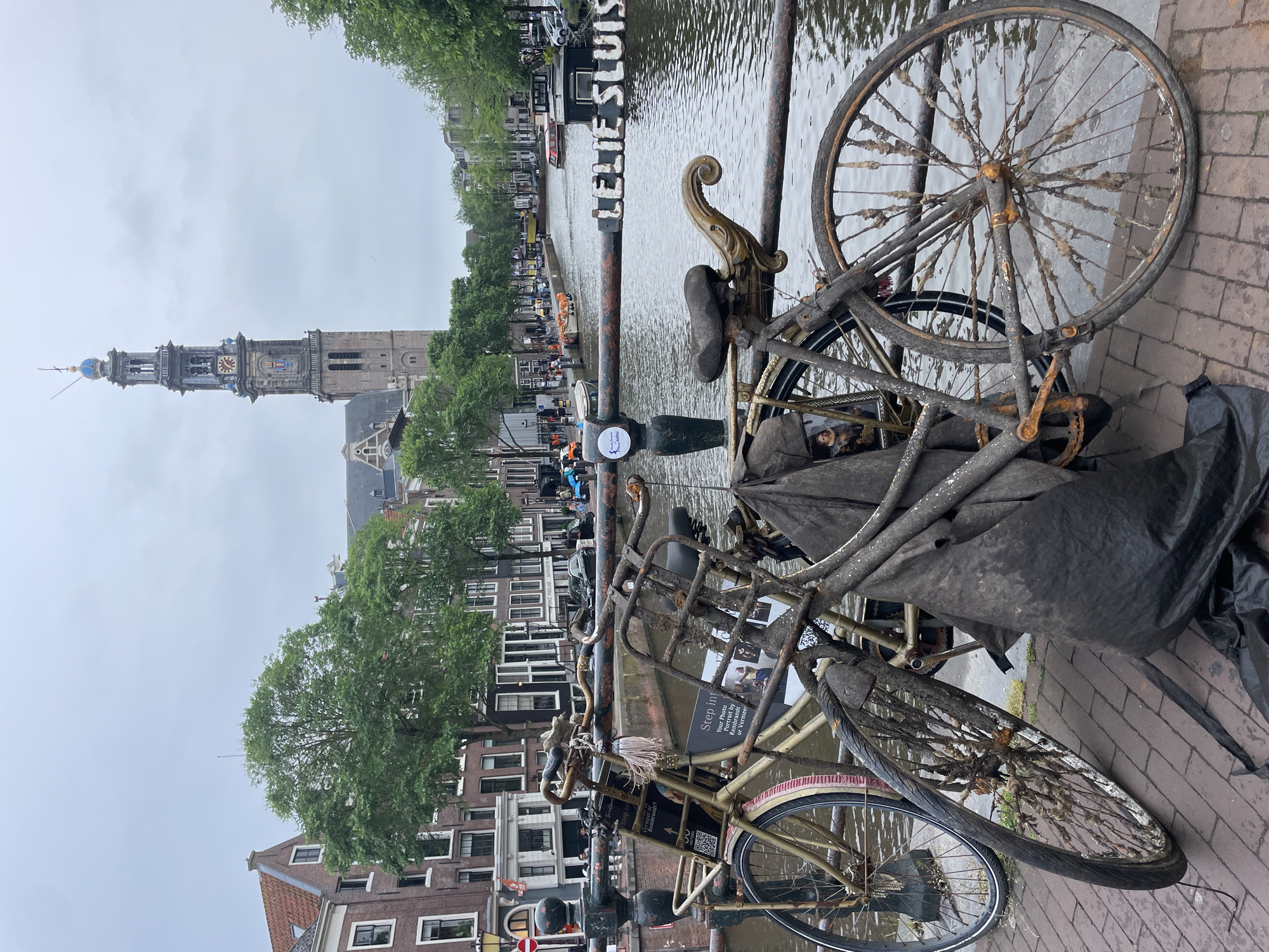 Tourist captures classic Amsterdam canal scenes during evening stroll