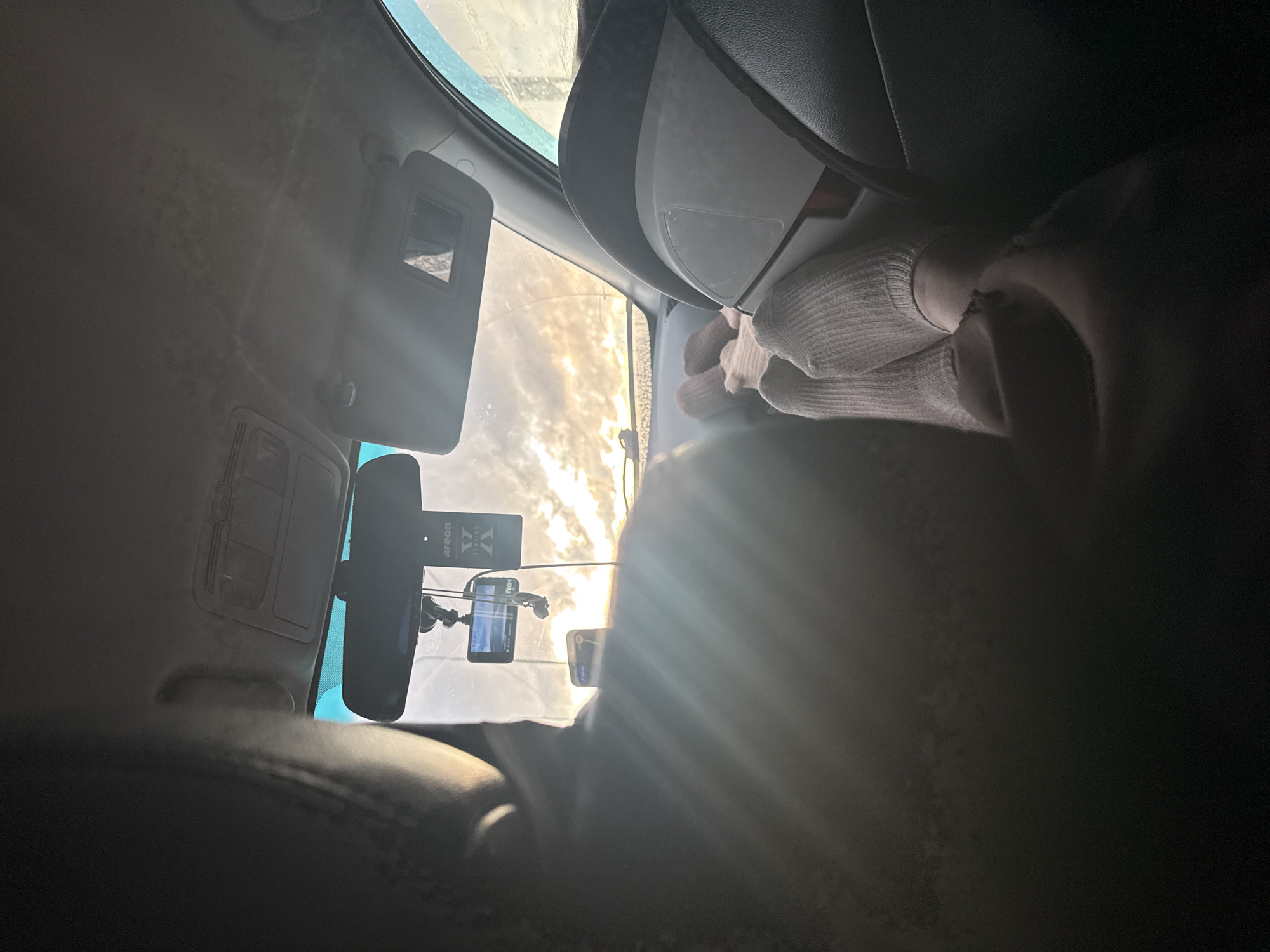 Bright sunlight creates glare through car windshield in Russia