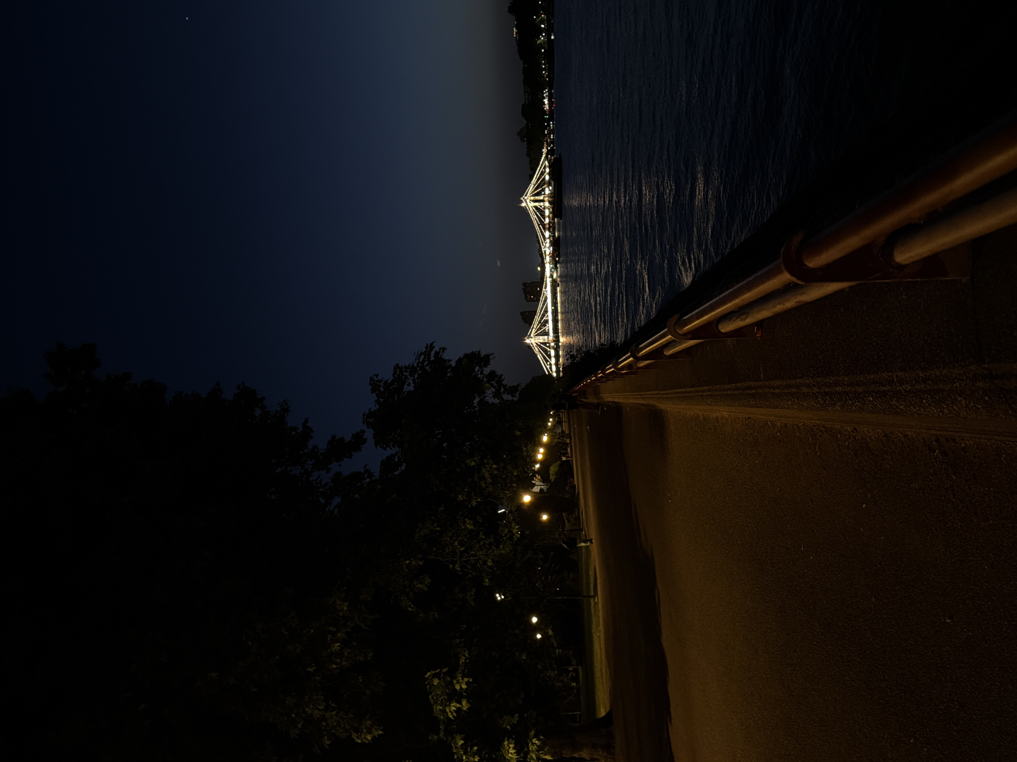 Hungerford Bridge illuminated at night over Thames