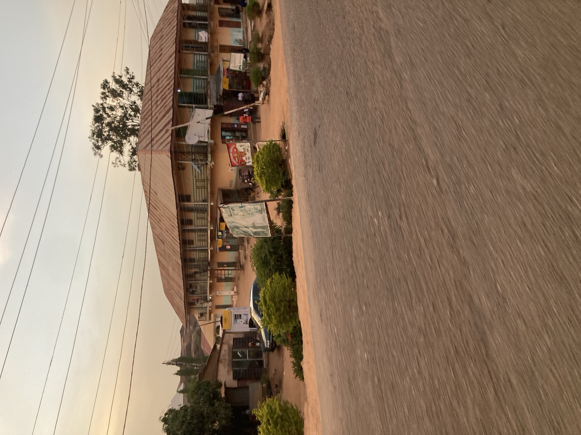 Moving vehicle captures street scene in Jos, Nigeria