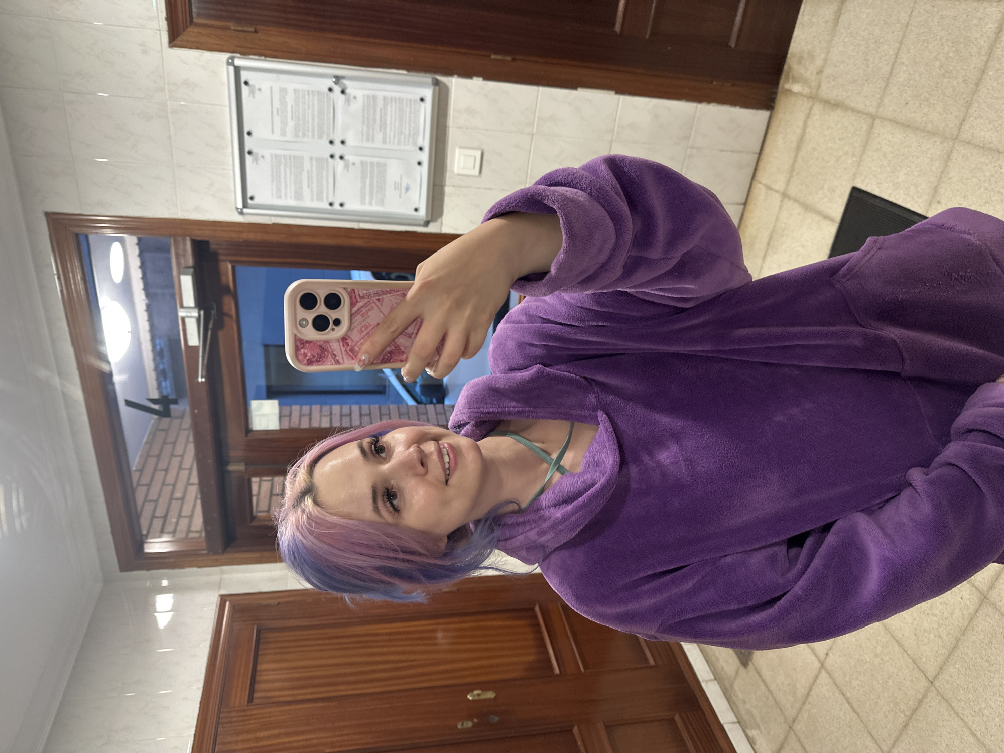 Woman takes selfie with pink phone in Gijón