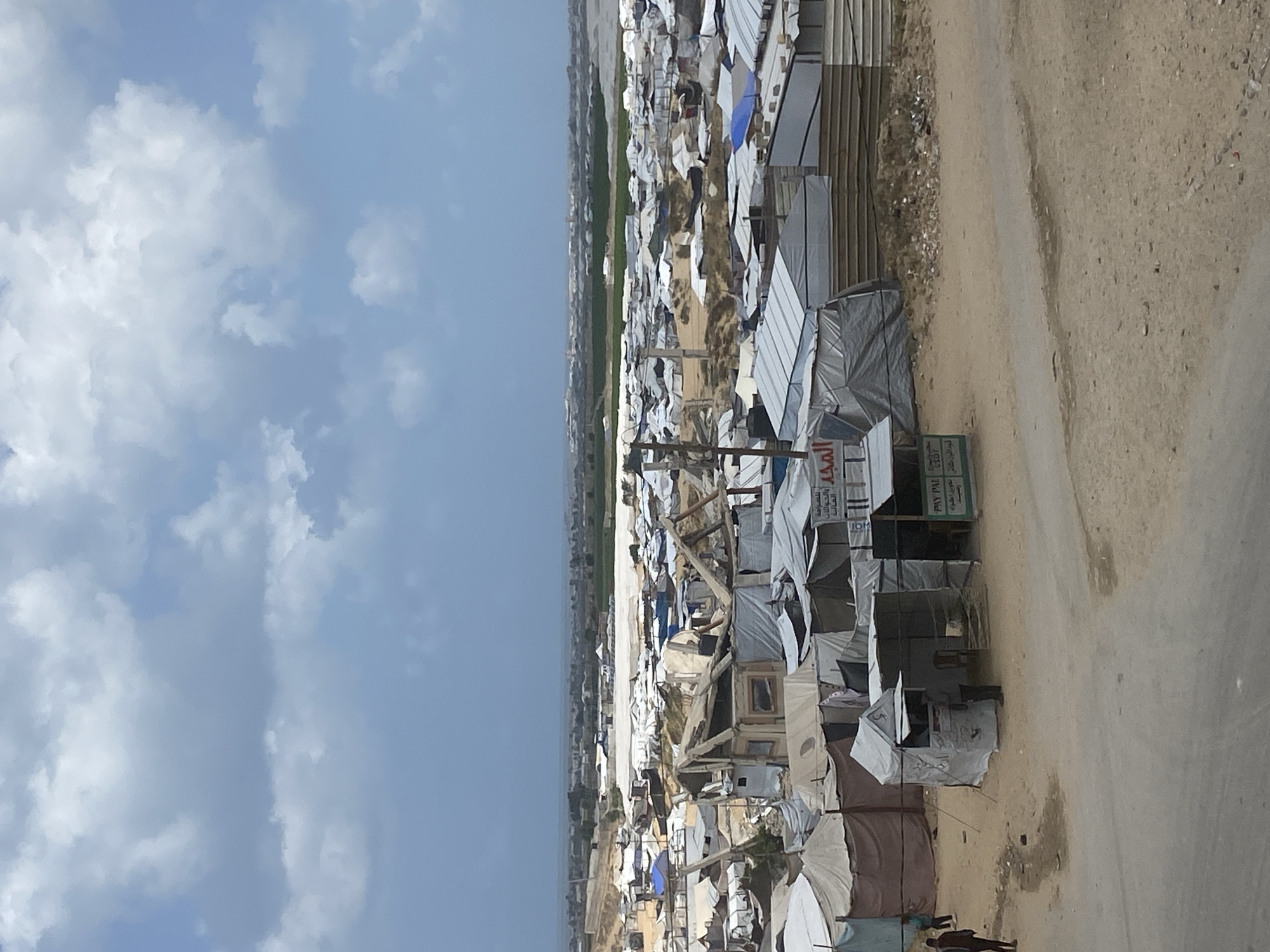 Refugee camp with makeshift shelters documented at unknown location