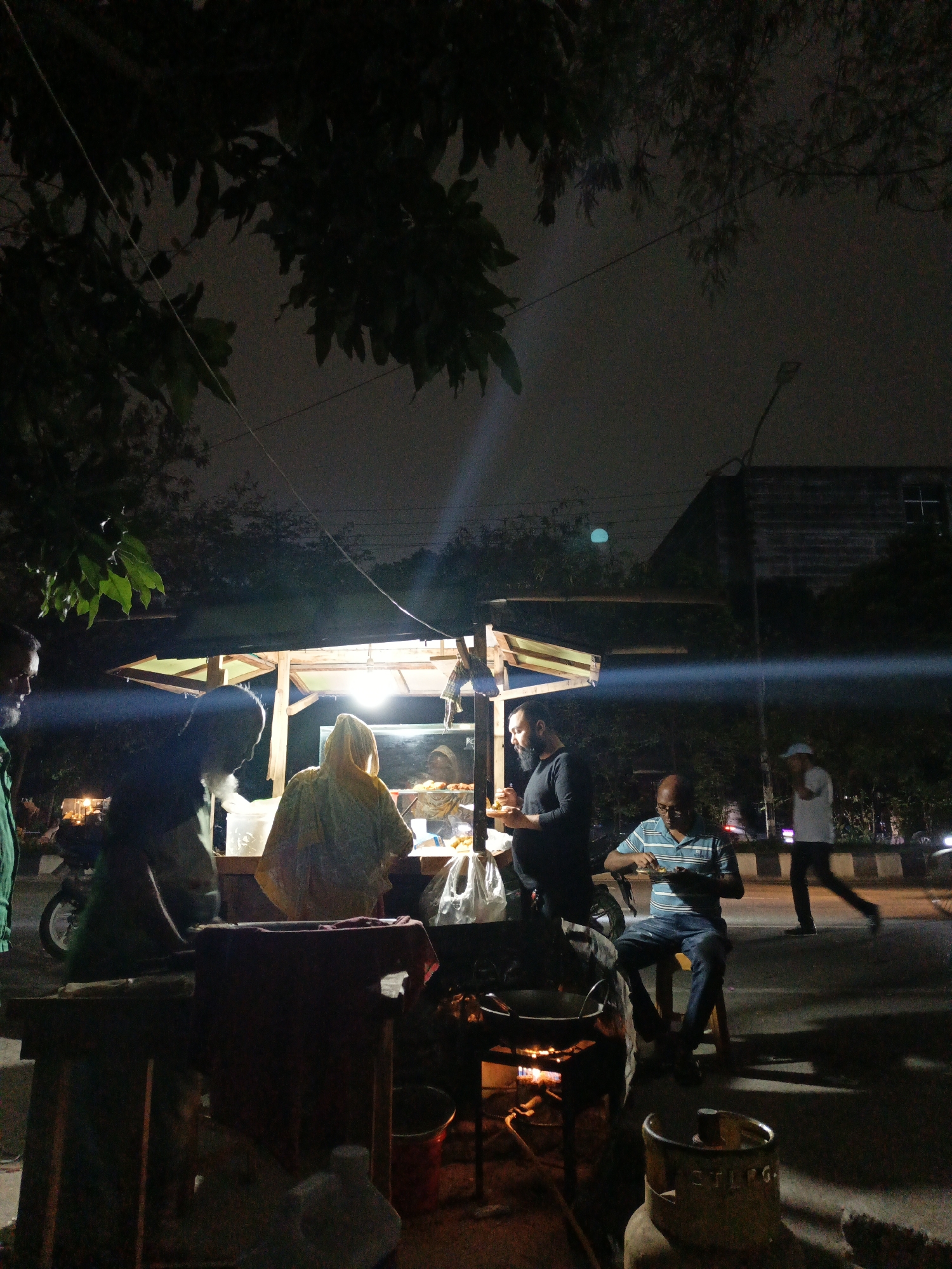 Evening street food vendor operates in Dhaka