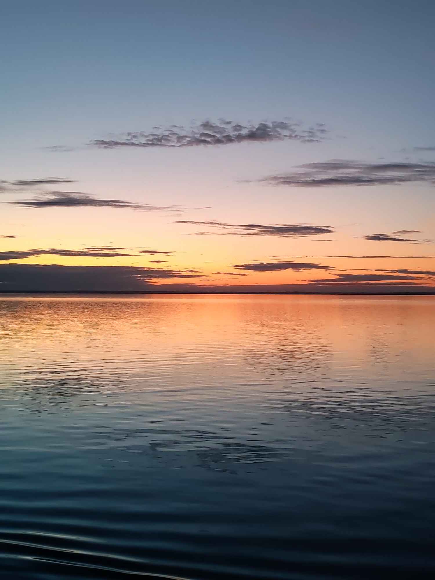 Maritime sunrise captured from cargo ship deck in Russia