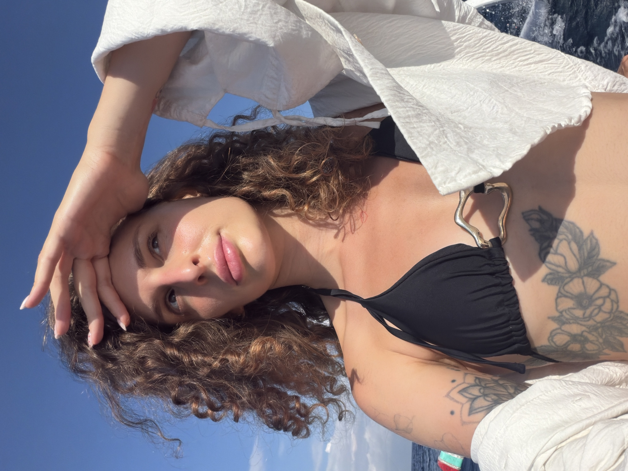 Woman enjoys boat trip along Indonesian coastline near Abang