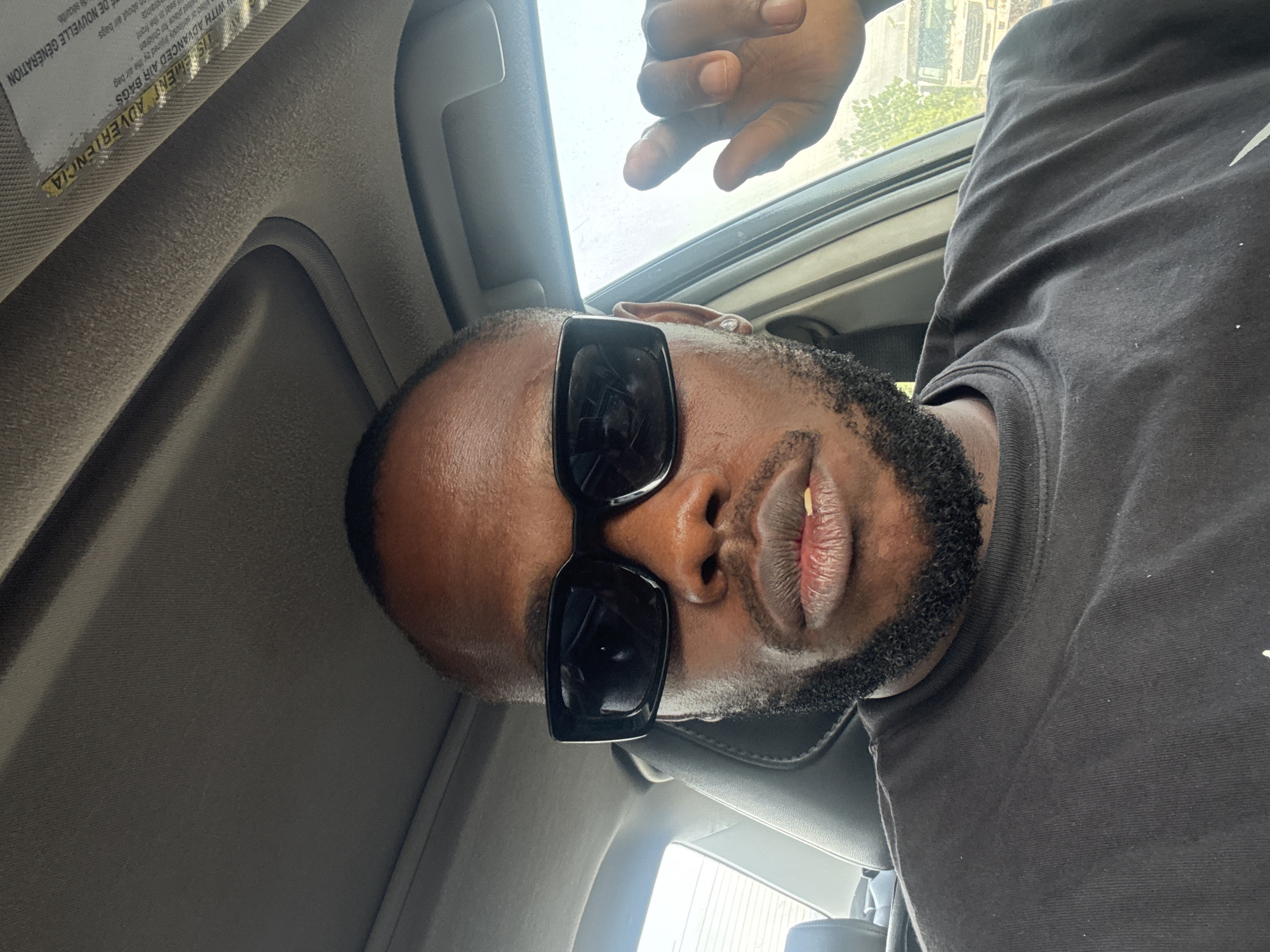 Car journey documented through selfies across Nigerian neighborhoods
