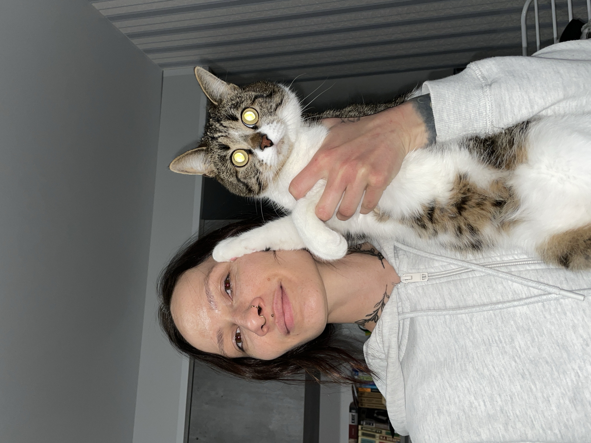 Woman holds cat indoors in Izhevsk, Russia
