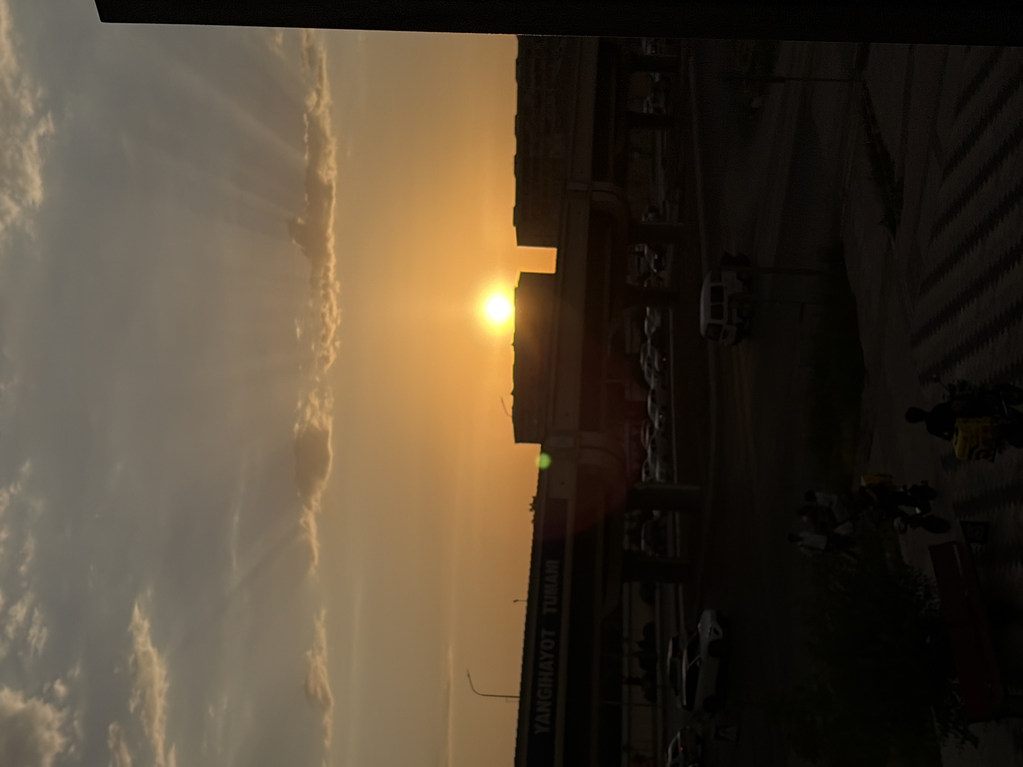 Tashkent overpass frames a dramatic orange sunset sky