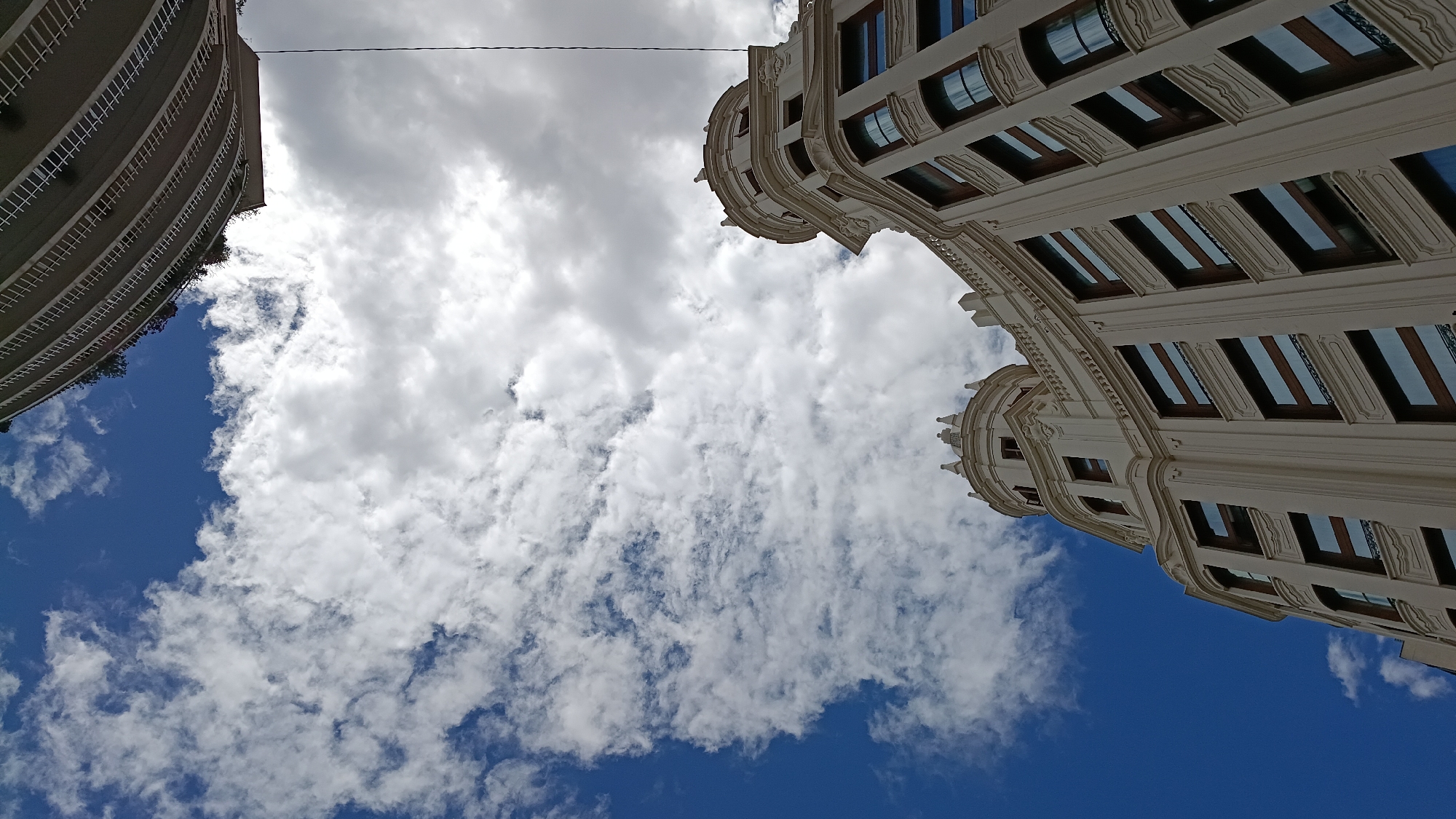 Valencia street scenes captured including ornate building and graffitied storefront