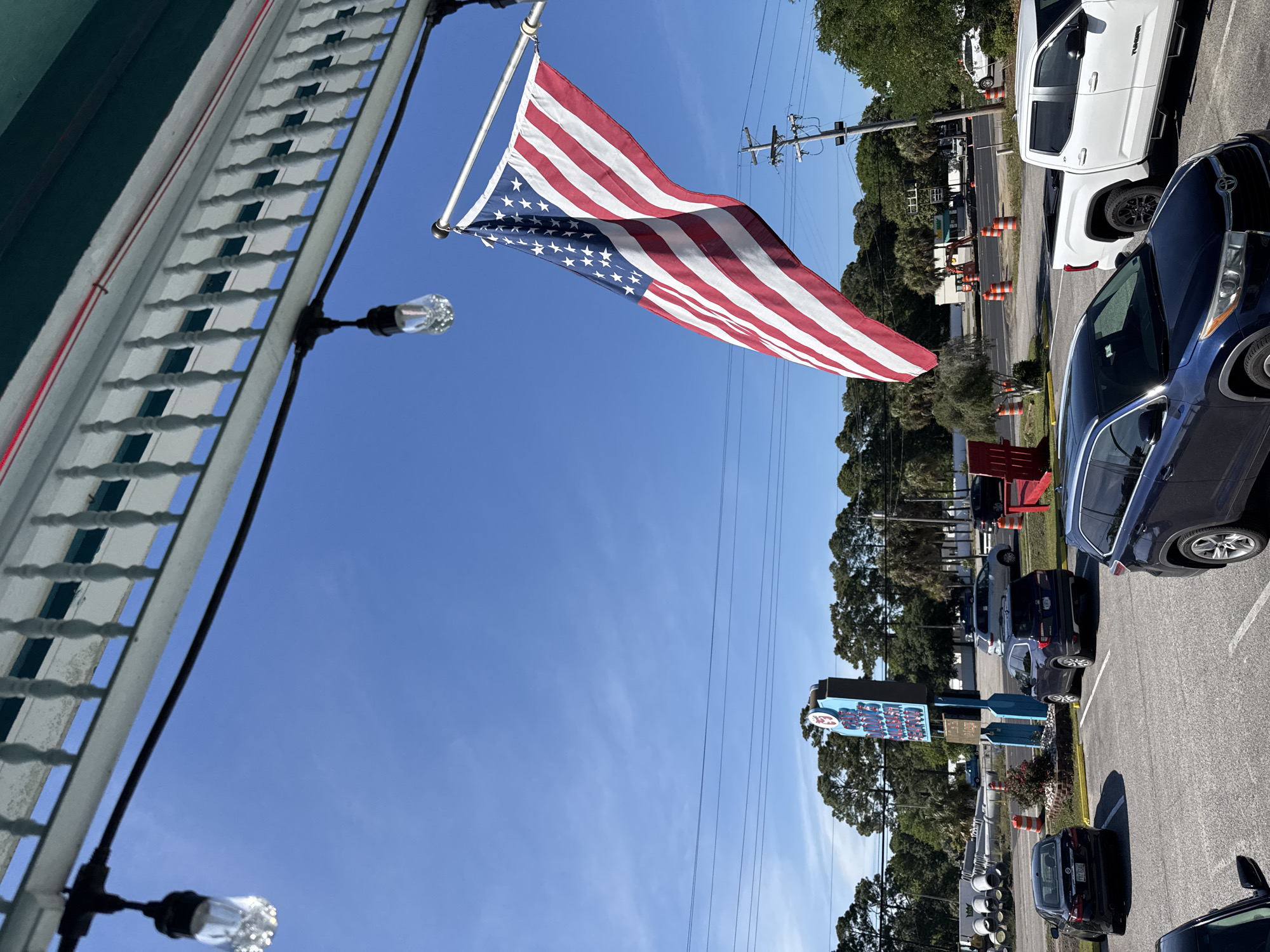 American flag flies on sunny day at Garden City Beach
