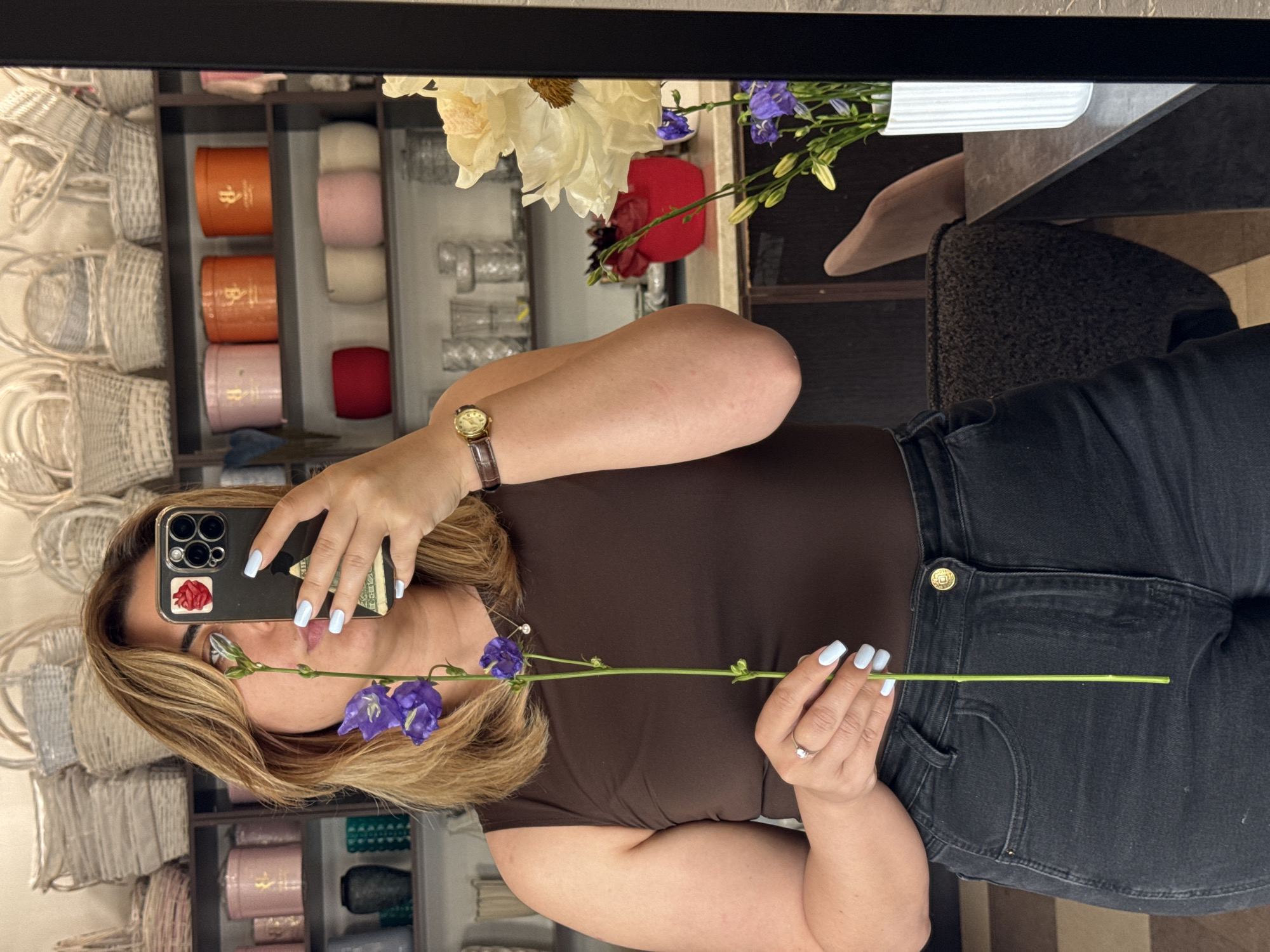 Mirror selfies with purple bellflowers in a retail store