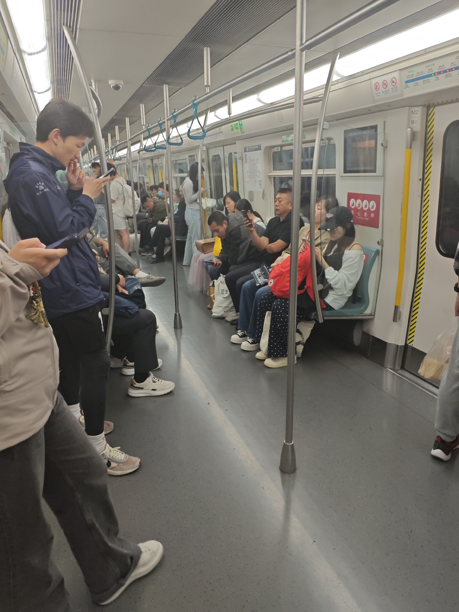 Morning subway commute observed with passengers, phones, transit staff