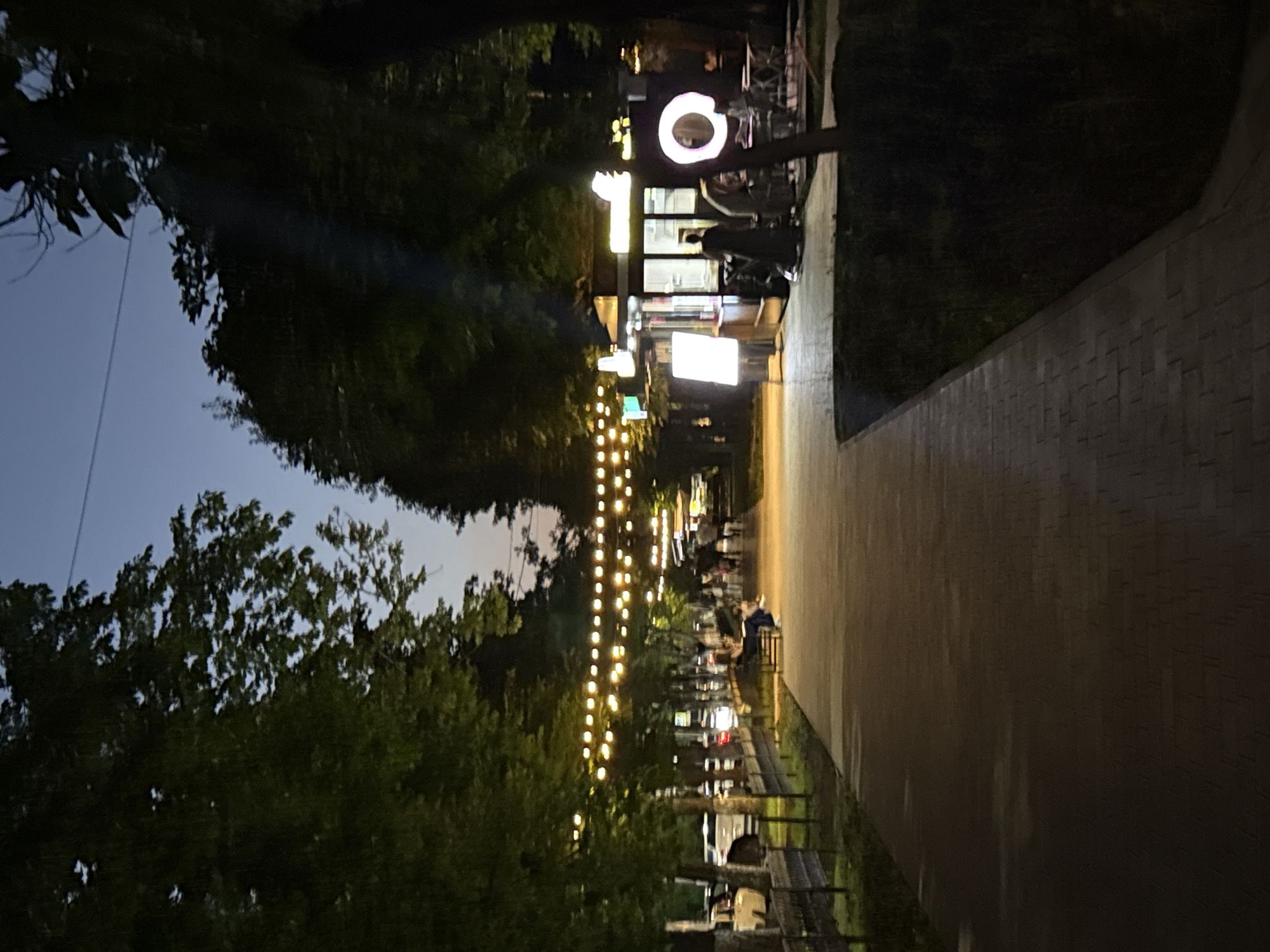 Nighttime stroll along a lit walkway in Khasavyurt