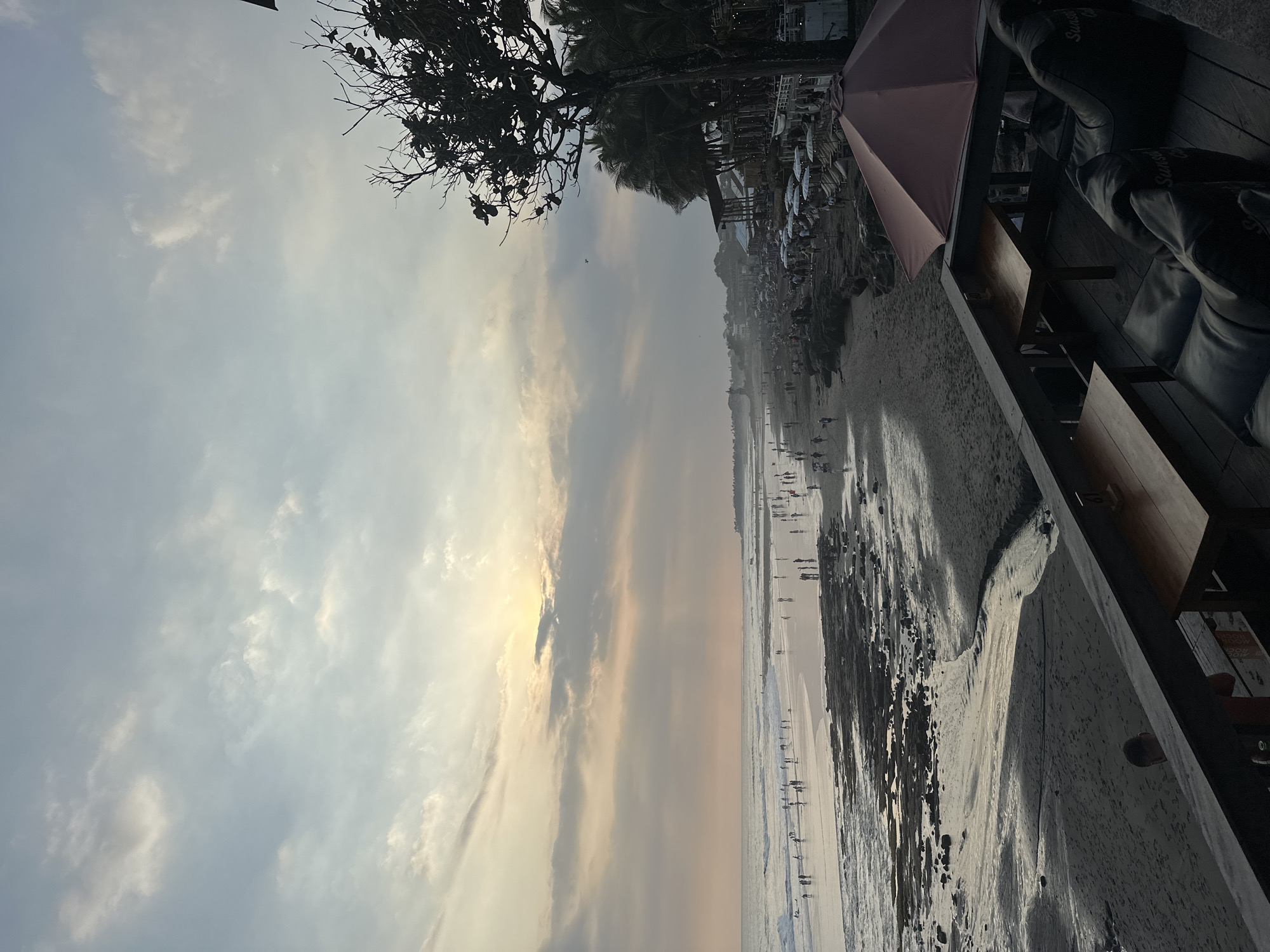 Sunset beach scene with shoreside dining and tide pools