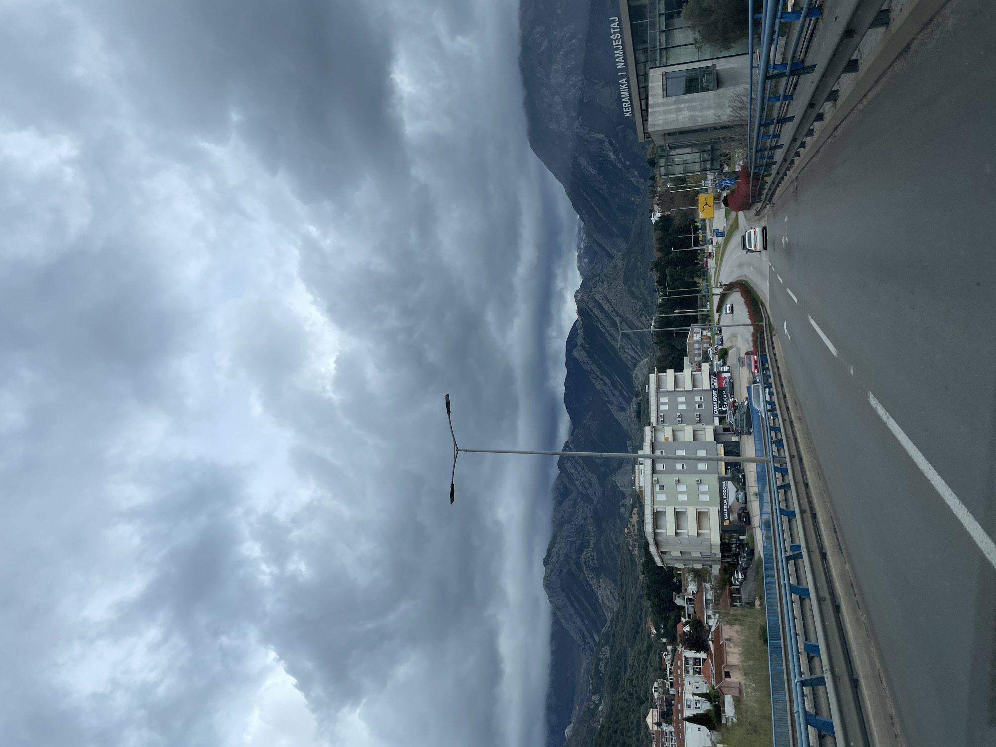 Driver travels elevated roadway in Bjeliši under overcast skies