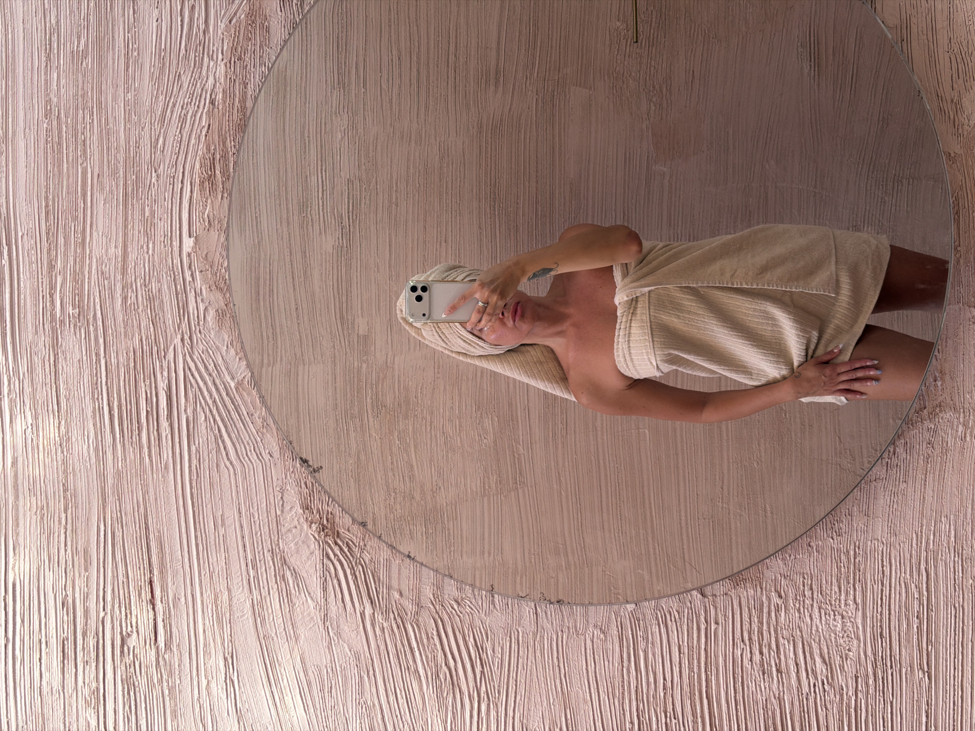 Woman takes towel selfie in mirror, North Kuta Indonesia