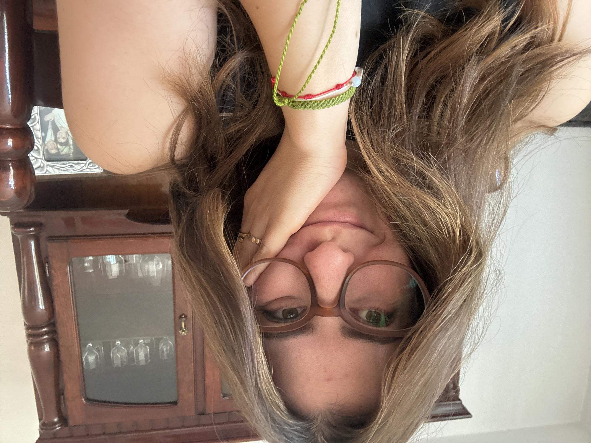 Woman documents video editing session with playful poses in Puebla
