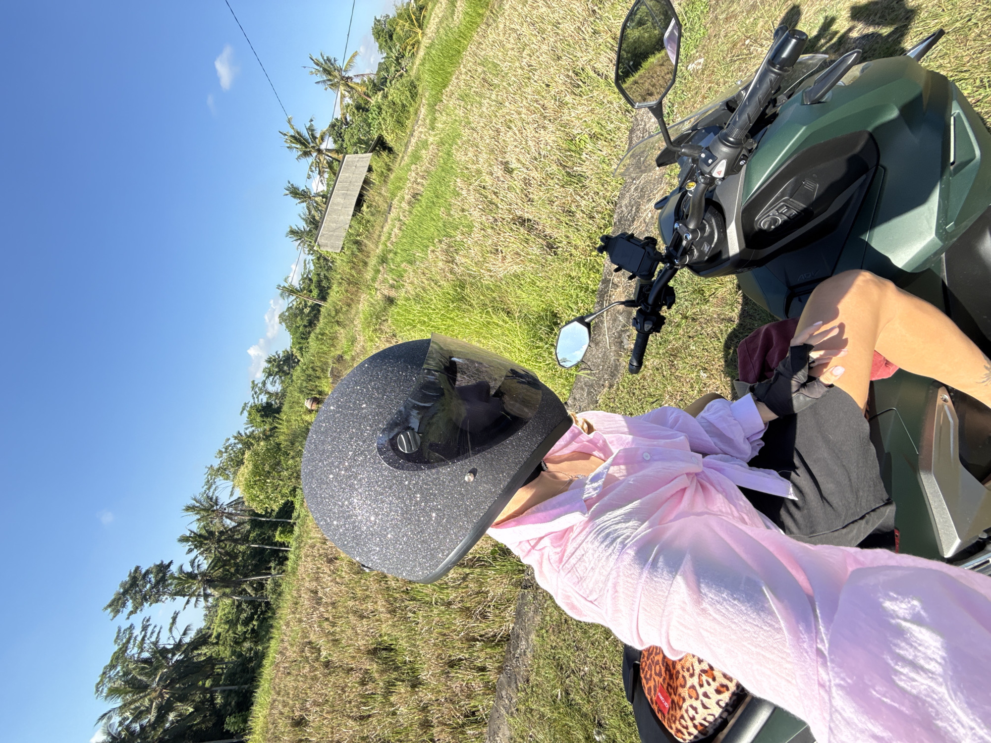 Scooter rider spotted in Ubud rice fields, Indonesia