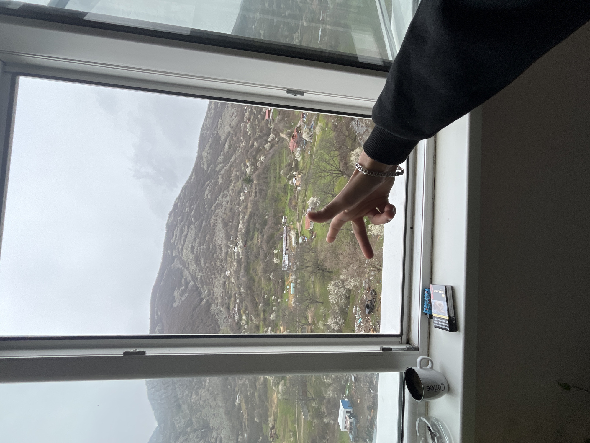 Person enjoys coffee break with mountain views in Sopot