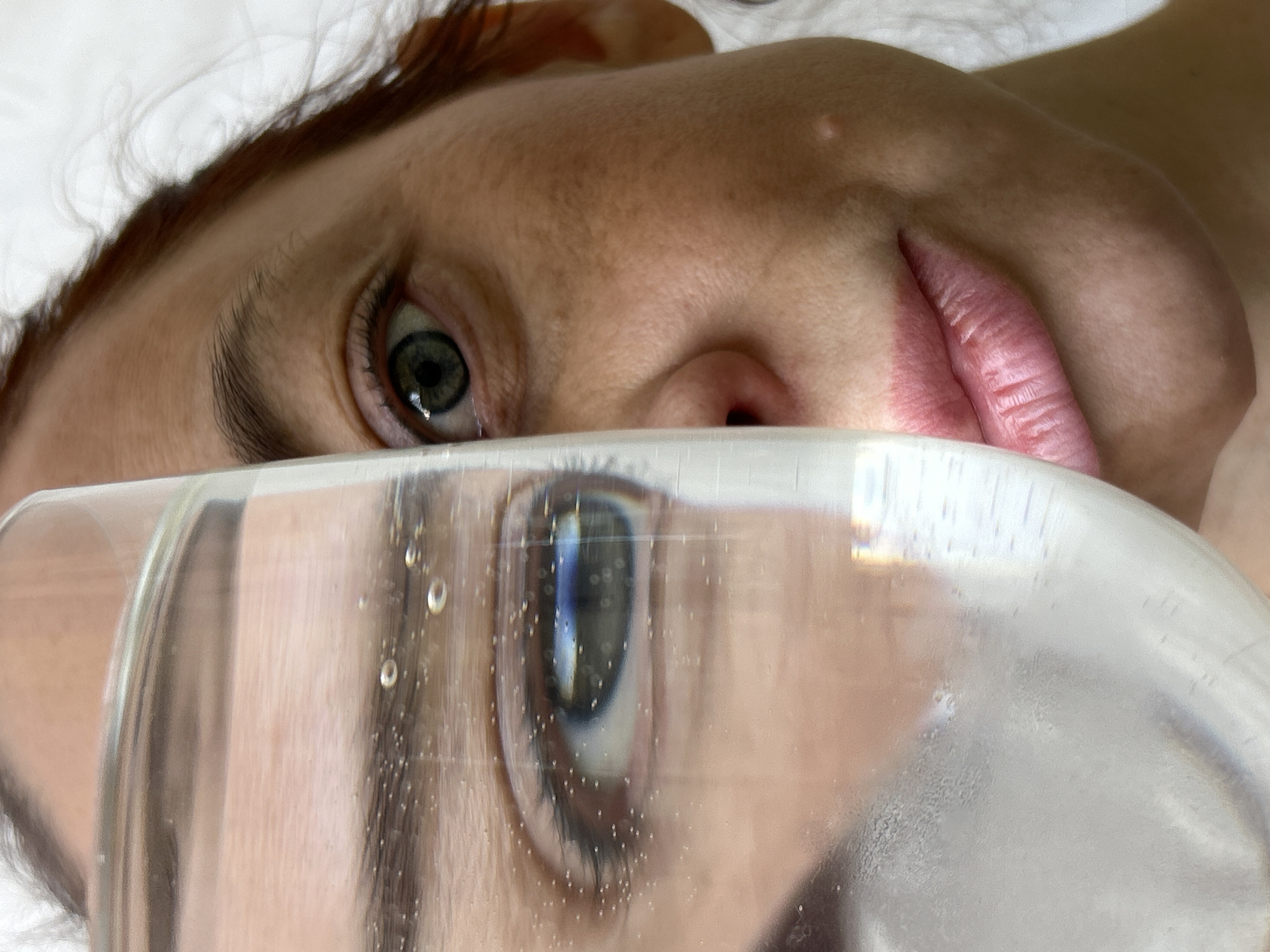 Person photographed through water glasses in Chaikovsky, Russia