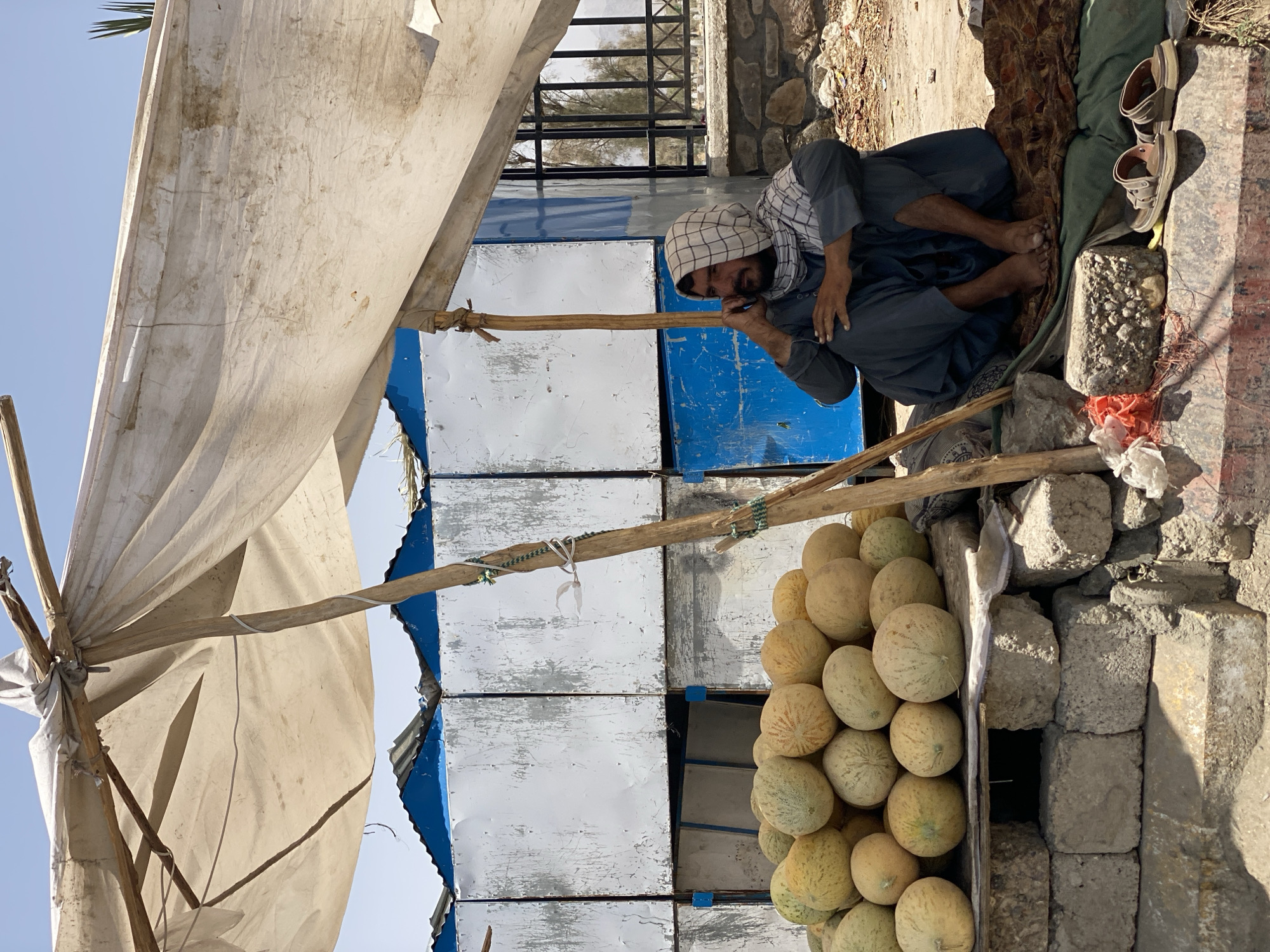 Kandahar street life: vendors, foot traffic, and open road