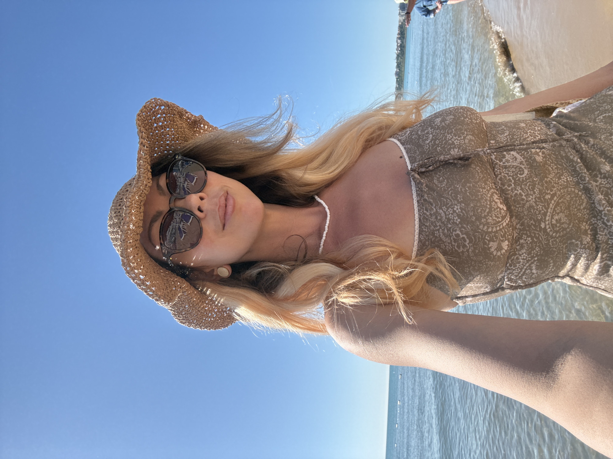 Woman takes morning selfies on Nesebar beach