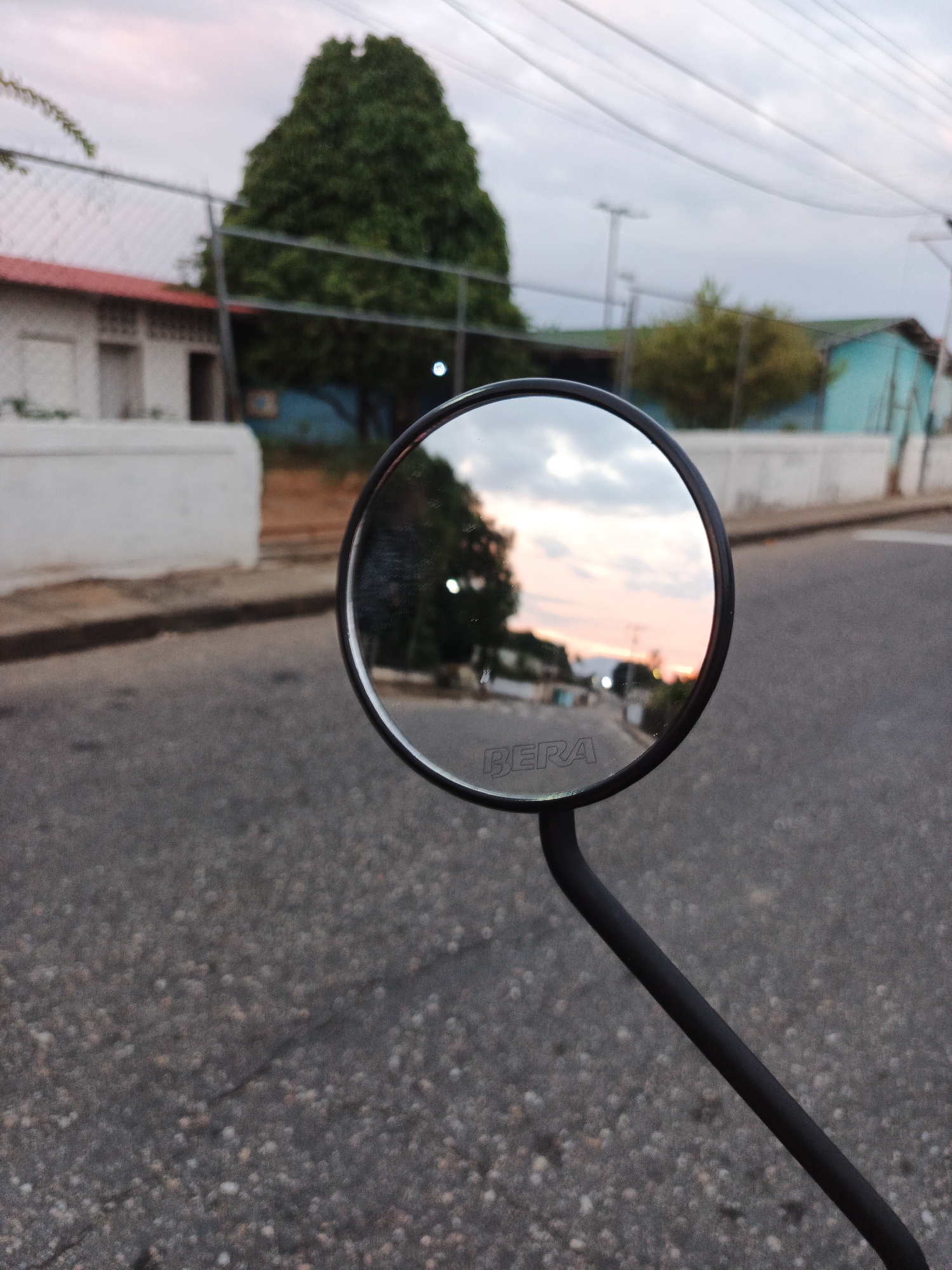 Motorcycle mirror captures street view in Tinaco, Venezuela