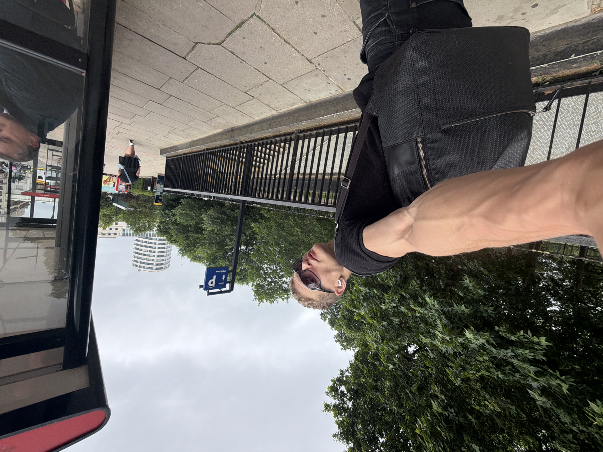 Quiet London bus stop scene under overcast skies