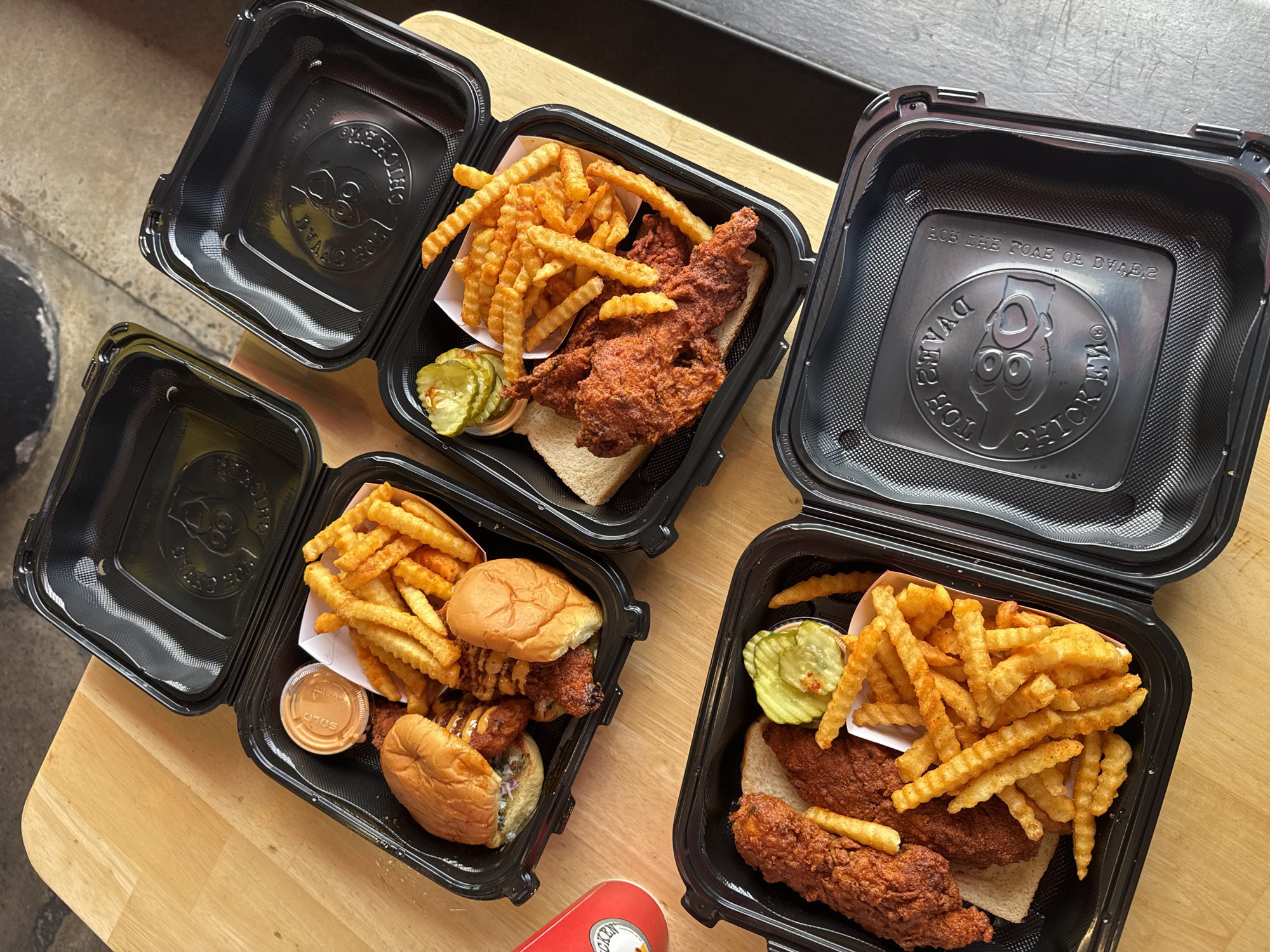Takeout chicken meals photographed in San Diego dining setup