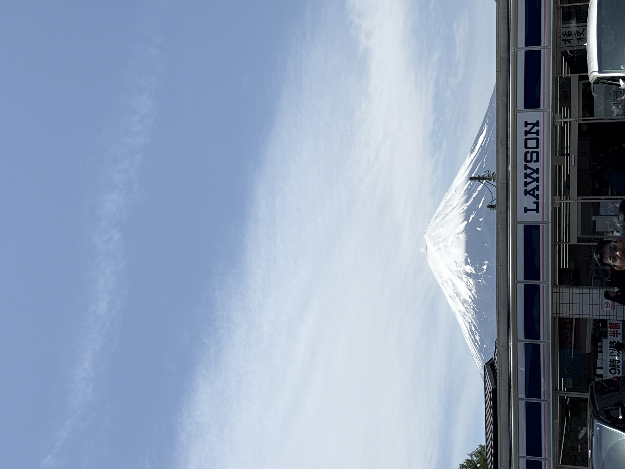 Clear day view of Mount Fuji behind Lawson store