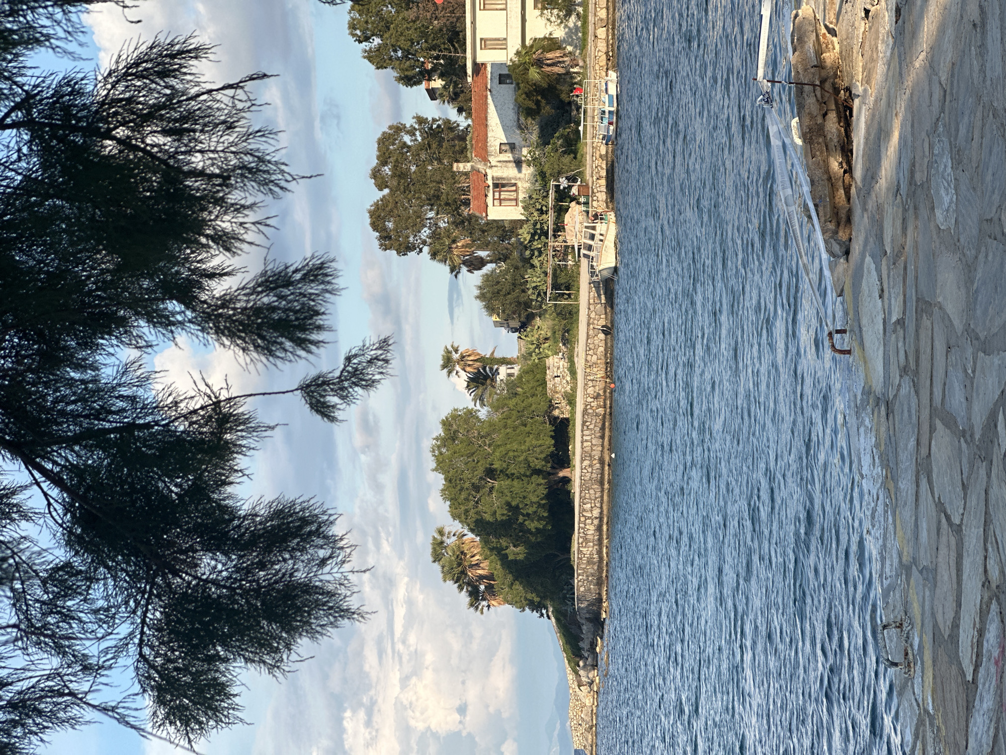 Children spotted on stone waterfront walkway in Datça, Turkey