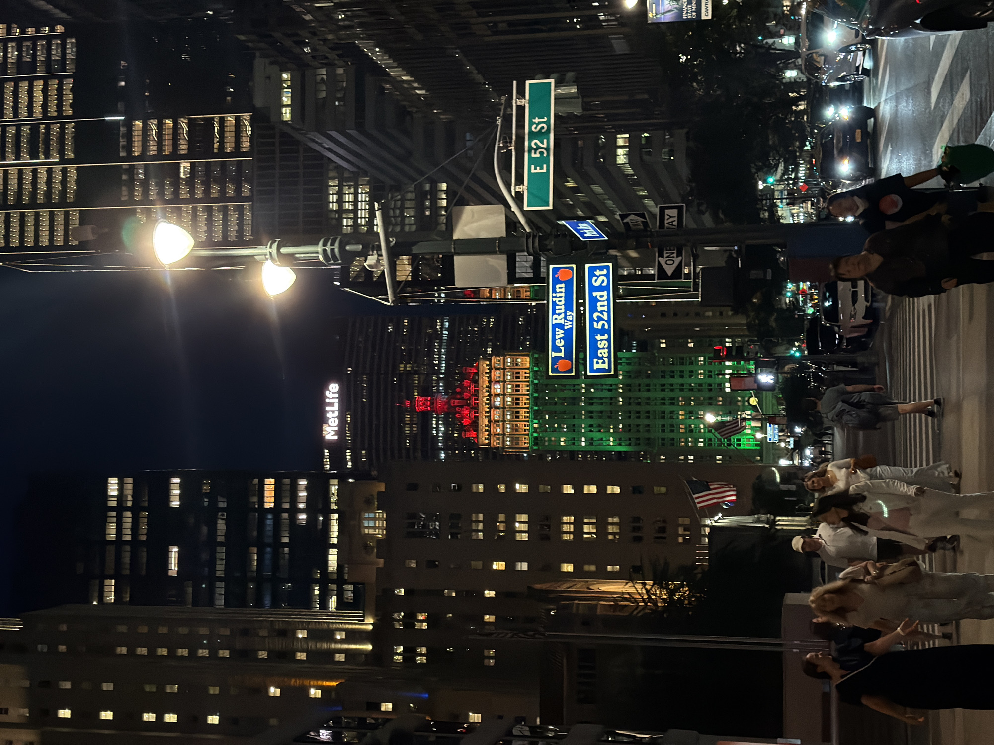 Midtown Manhattan intersection glowing after midnight