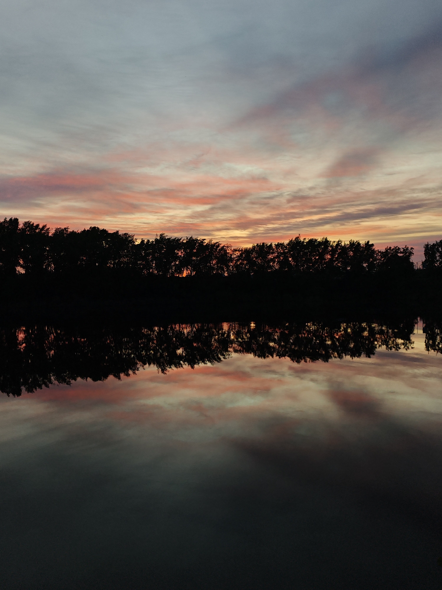 Sunset observed over water in Chaikovsky, Russia