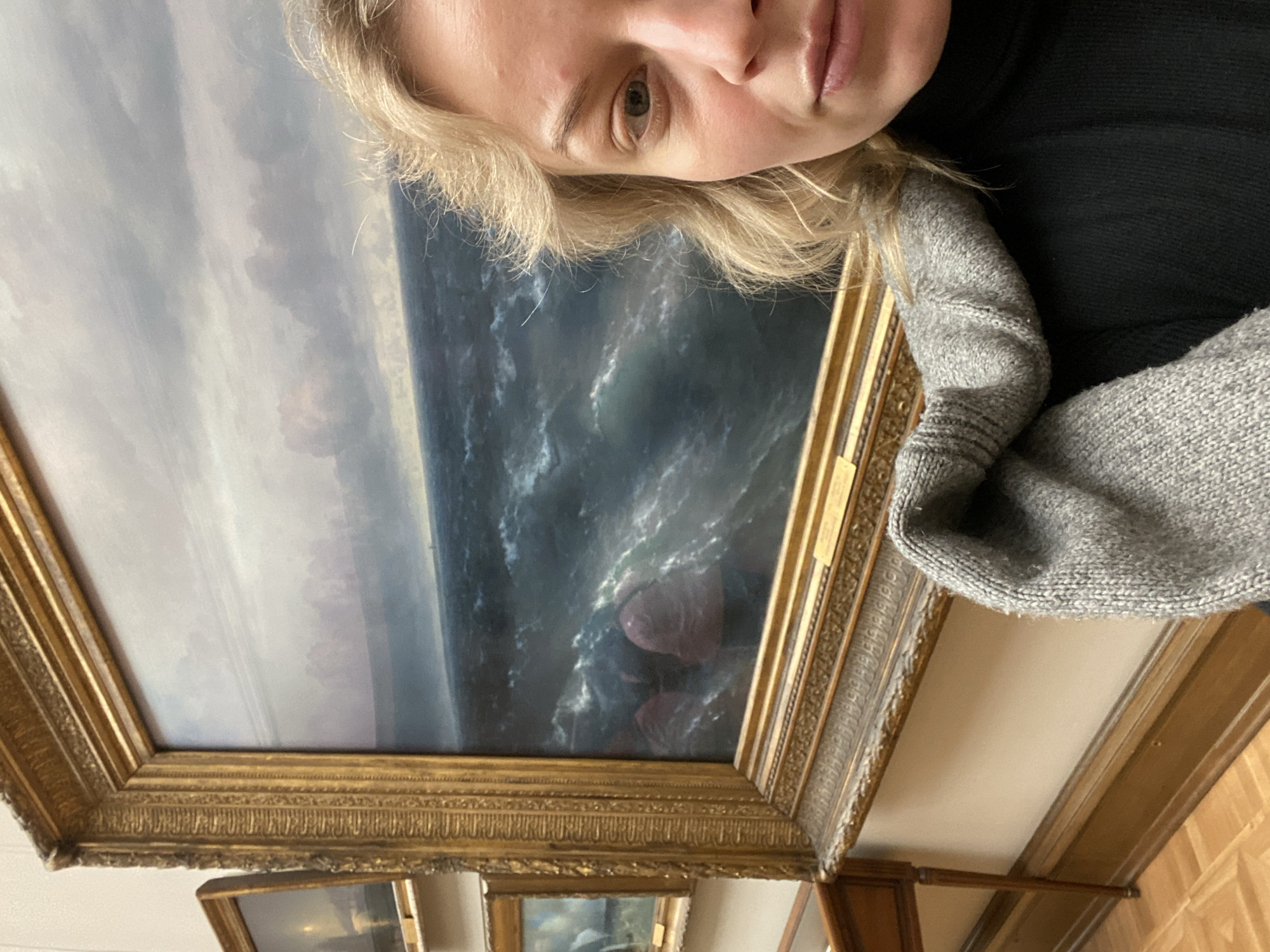 Woman poses with artwork in Moscow indoor setting