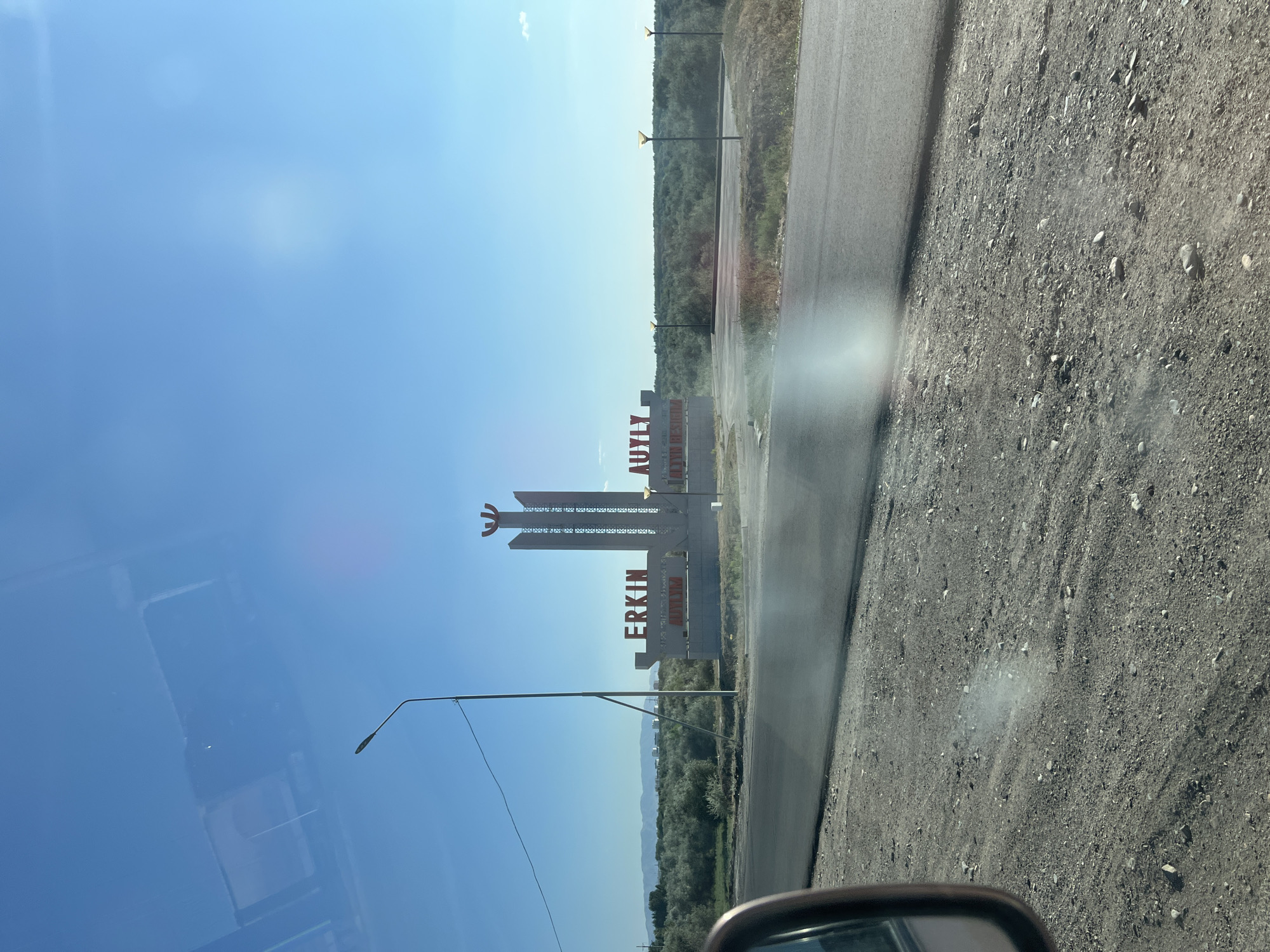 Kazakh flag cap and city monument in Taldykorgan