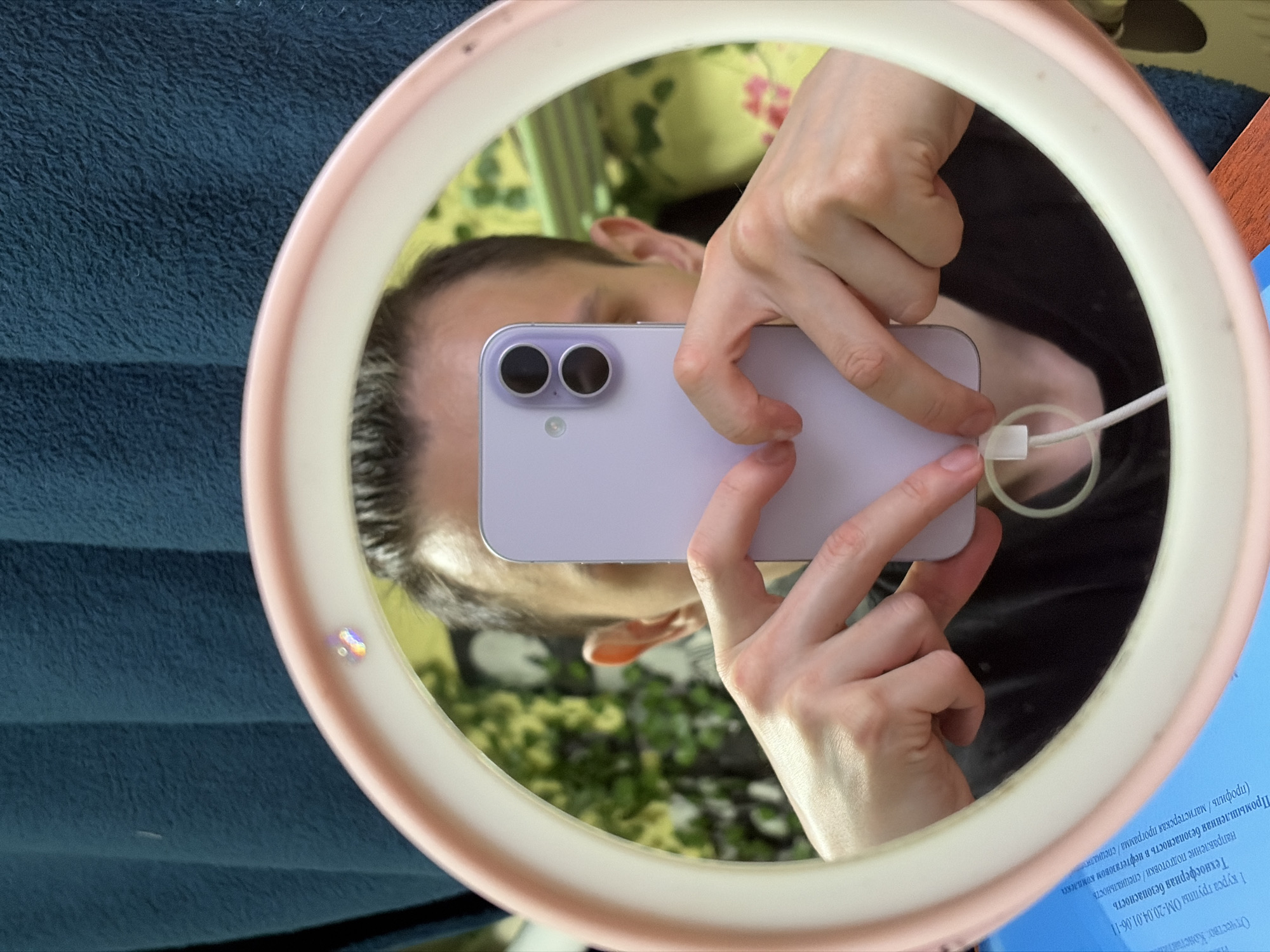 Ring light mirror selfie session with a lavender phone