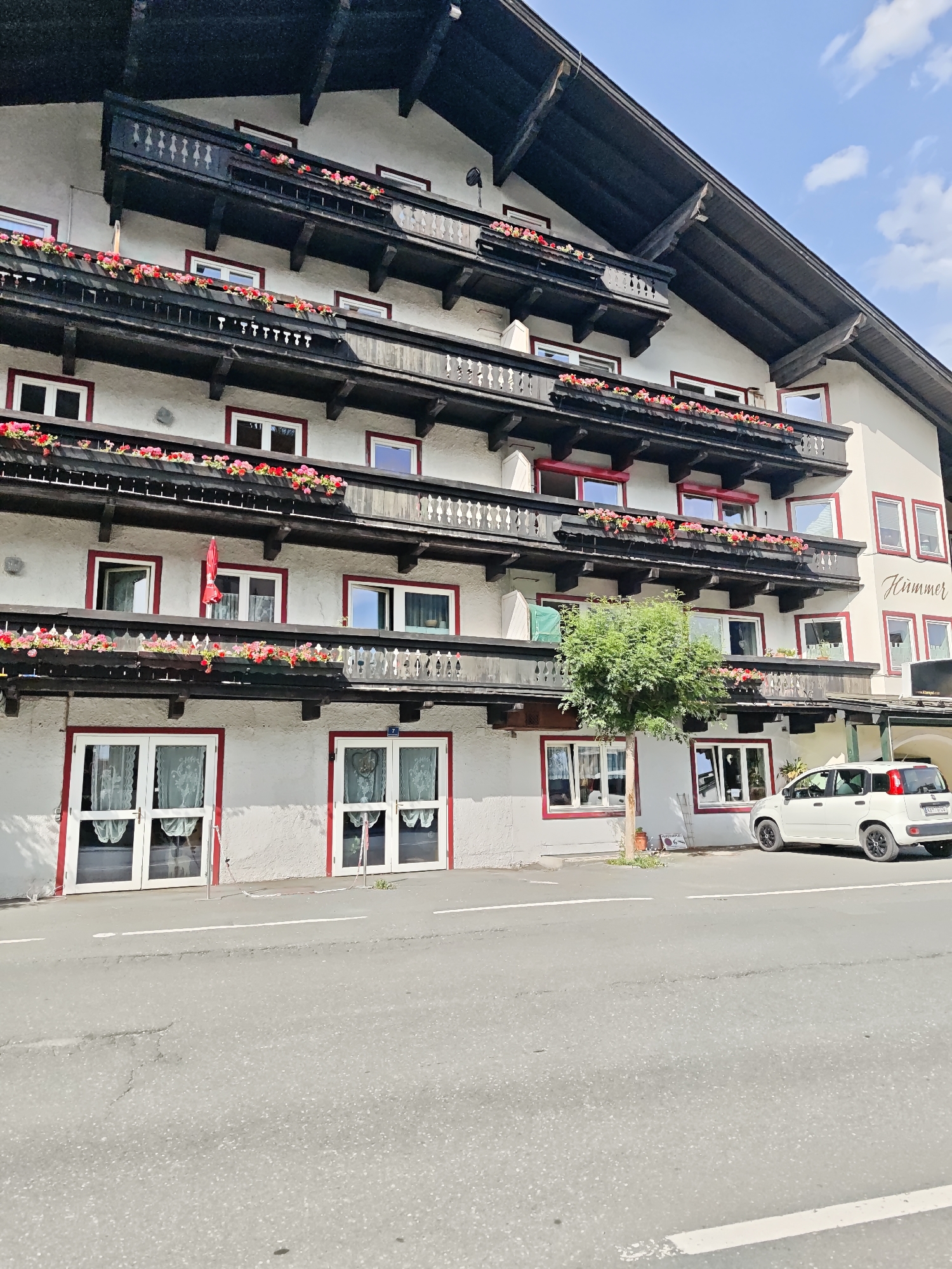 Strolling Kitzbühel's flower-lined streets on a summer afternoon