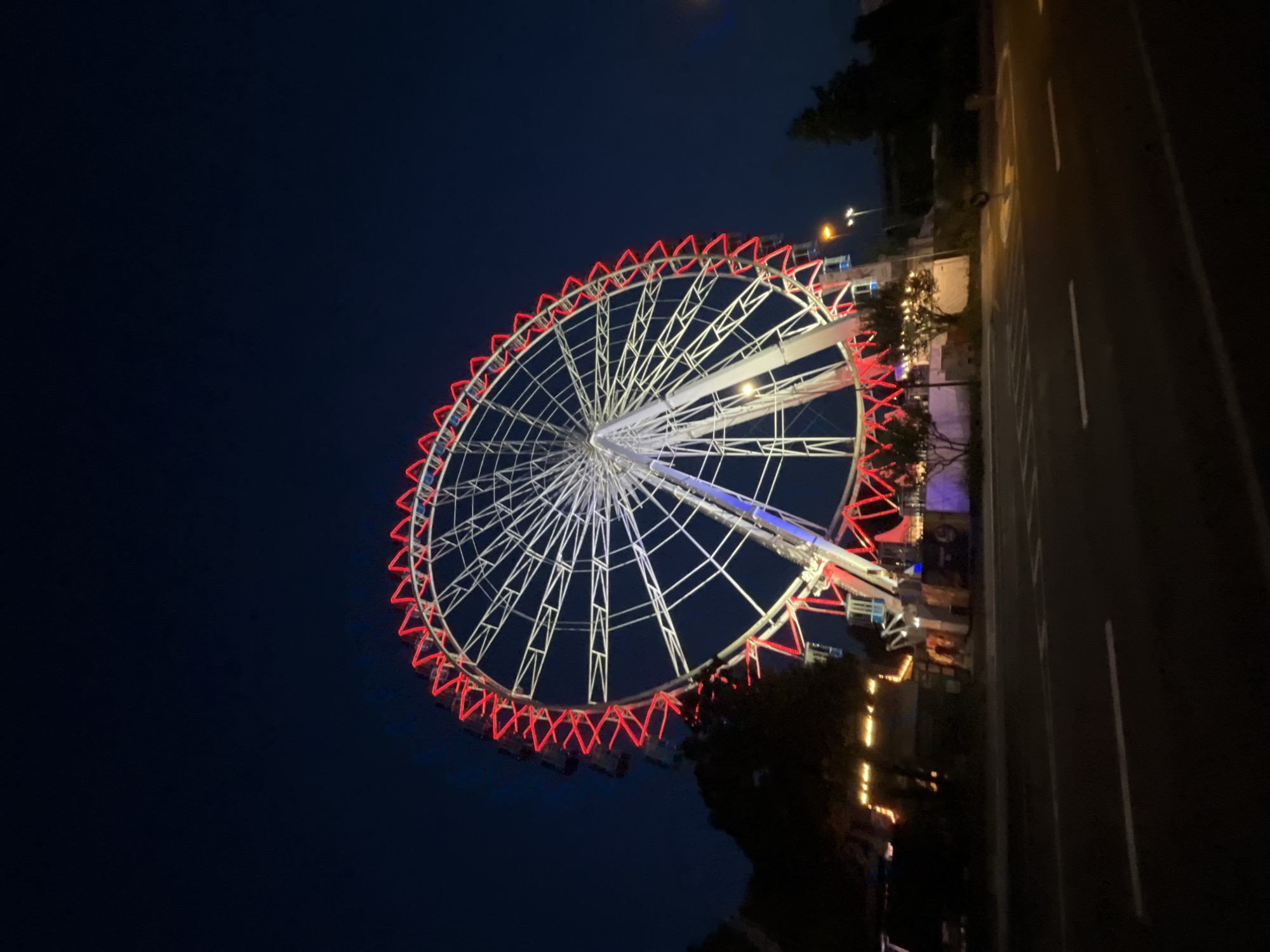 Ferris wheel and medieval minster light up a Neuss evening