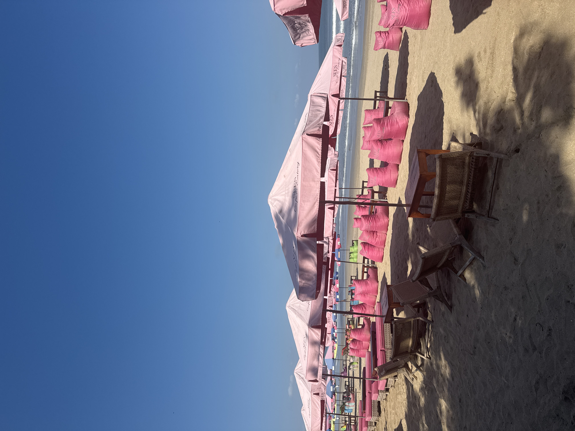 Kuta Beach scene: umbrellas, surf, and beachside bar