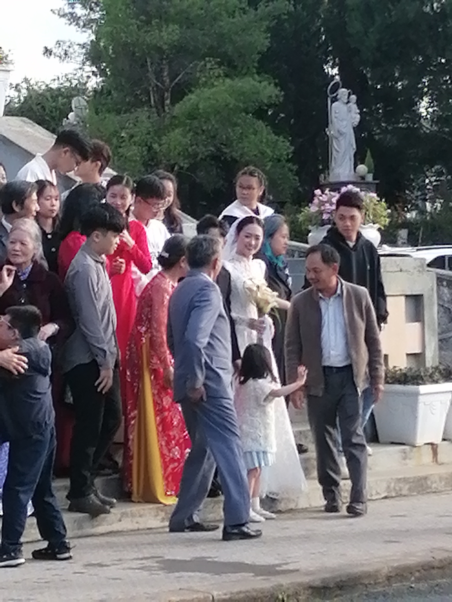 Wedding party at a Da Lat church courtyard, July 2026