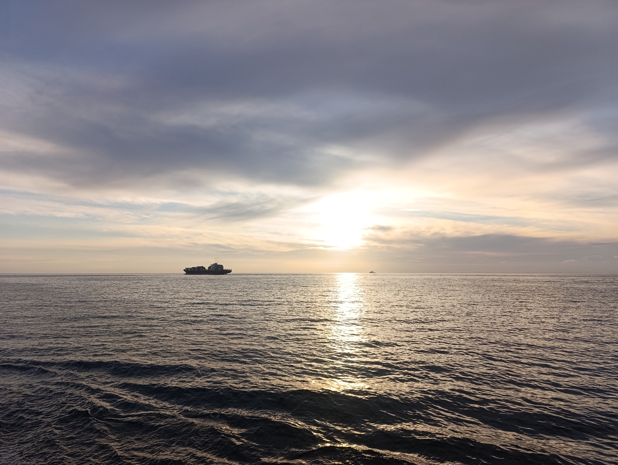 Cargo ship crosses the North Sea at golden hour