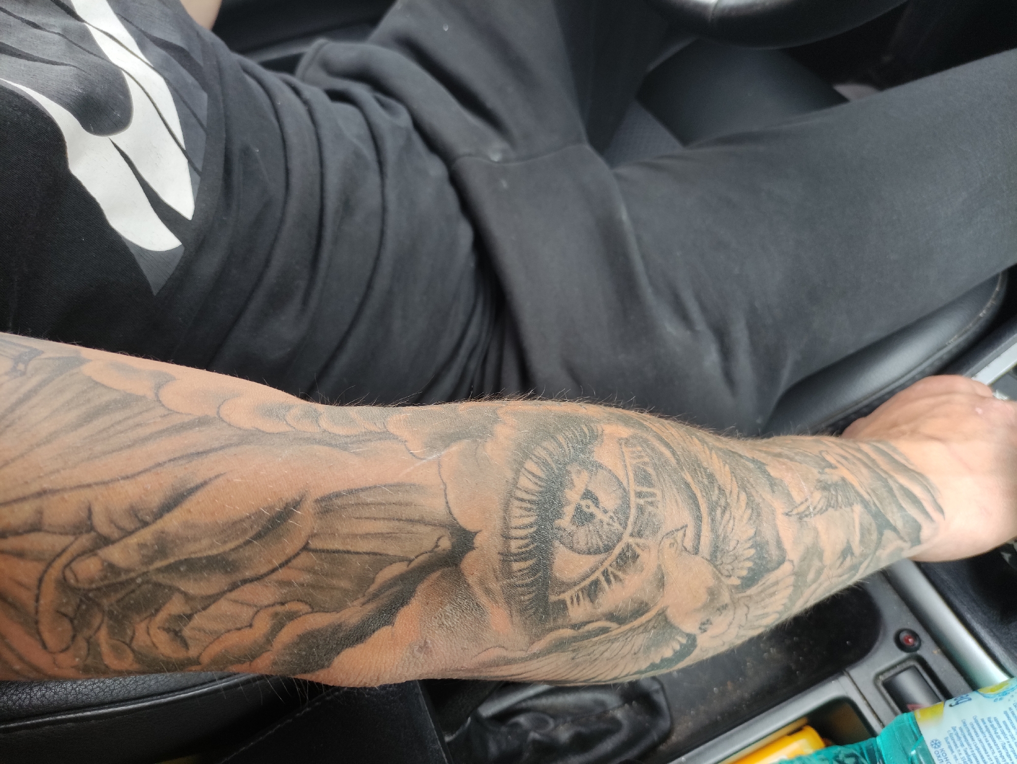 Tattoo art and car interior moments captured in Madan