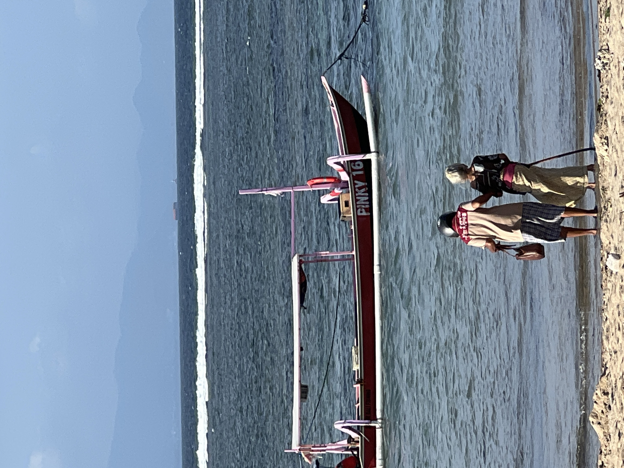 Sanur Beach promenade buzzing with cyclists, beachgoers, and street life