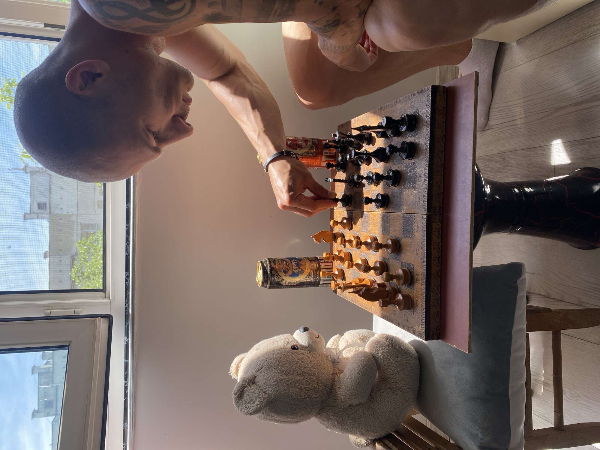 Man plays chess with teddy bear companion in Pleven