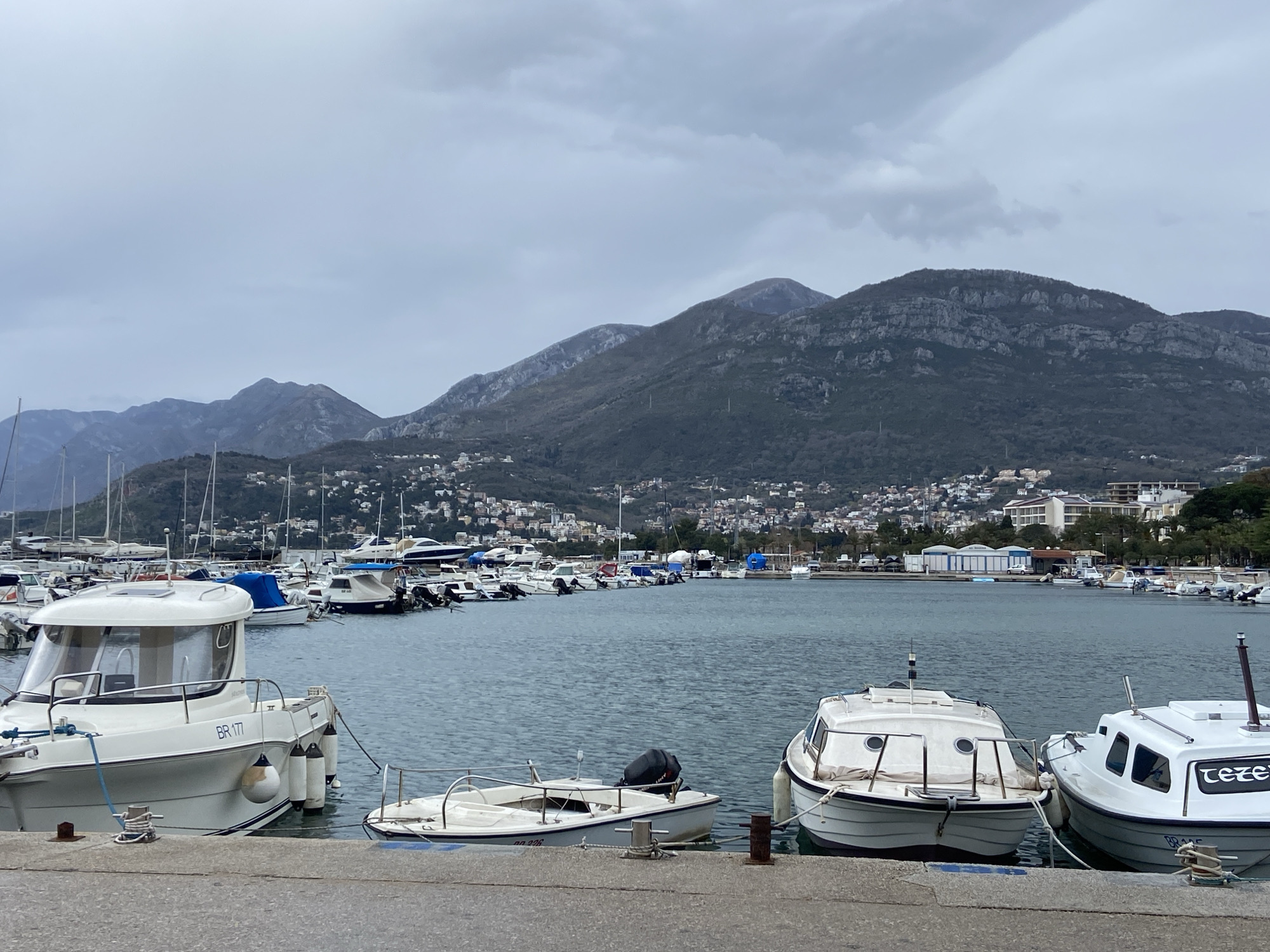 Tourists document marina and dining scenes in Bar, Montenegro