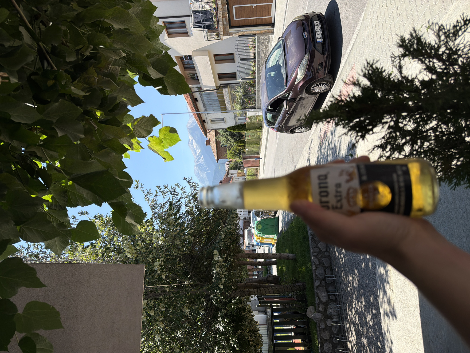 Summer afternoon in Bansko, beer in hand, mountains behind