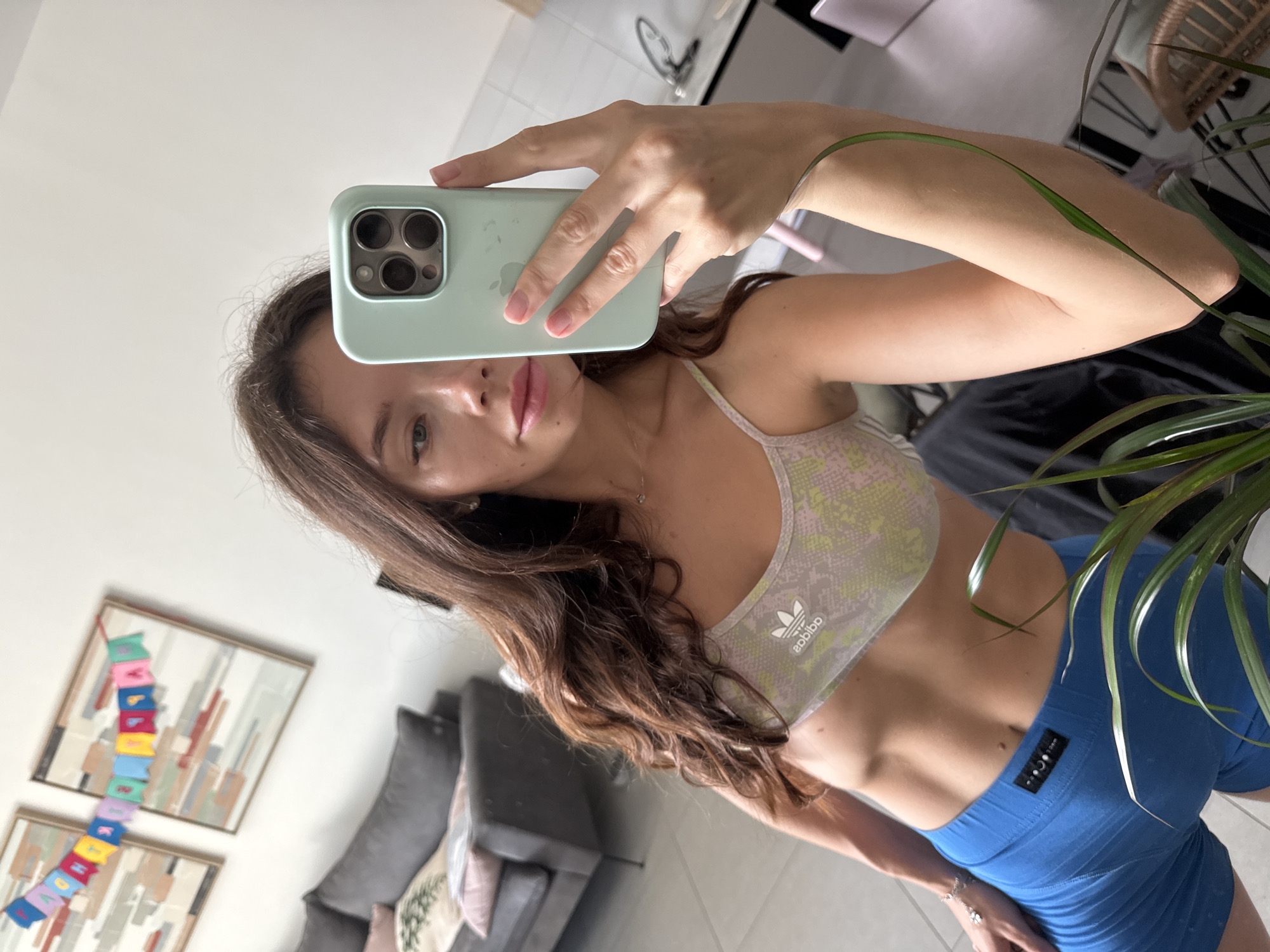 Indoor selfie in athletic wear, Adidas sports bra.